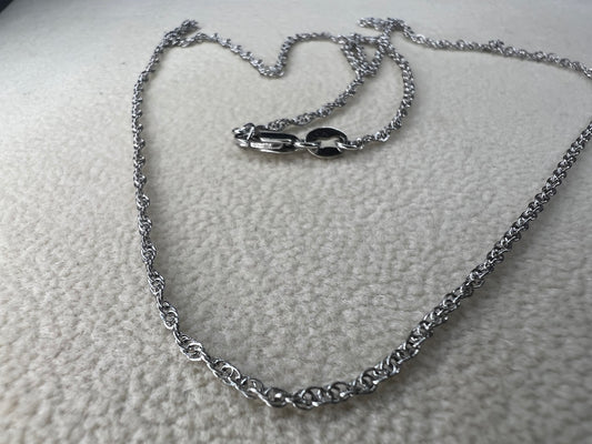 This petite sterling silver rope chain offers a delicate and elegant look, perfect for everyday wear. It pairs beautifully with smaller pendants or can be worn alone for a subtle touch of sophistication.