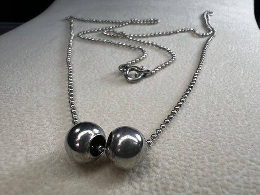 This 24" sterling silver chain and double charm bead necklace brings graceful movement to your look throughout the day. Made in Italy.