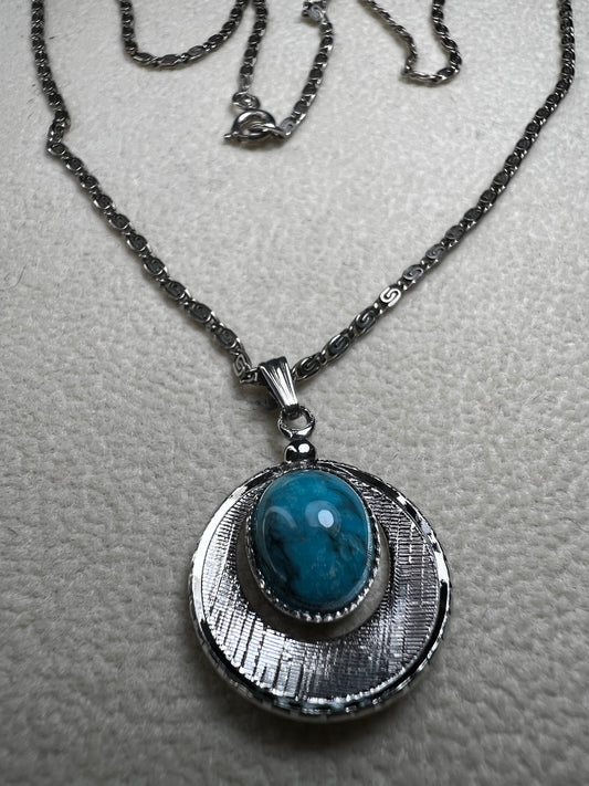 This 20" sterling silver scroll link chain paired with a faux turquoise pendant offers a timeless vintage style.