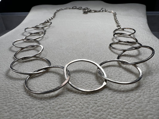 This 20" sterling silver ring and link necklace is thoughtfully crafted to add a touch of elegance and confidence to your favorite outfits. Let this necklace be the special piece that completes your wardrobe with grace and charm.