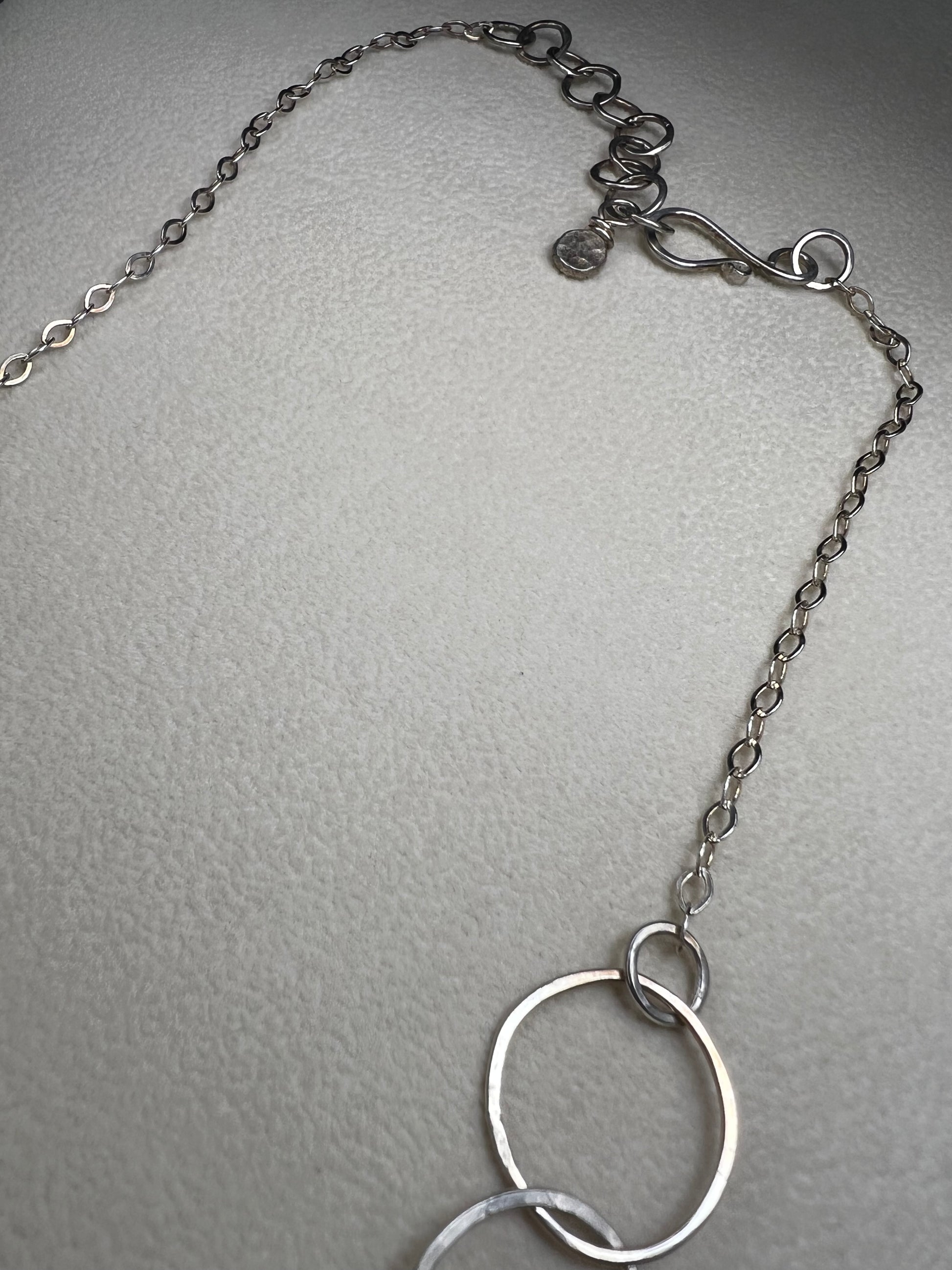 This 20" sterling silver ring and link necklace is thoughtfully crafted to add a touch of elegance and confidence to your favorite outfits. Let this necklace be the special piece that completes your wardrobe with grace and charm.