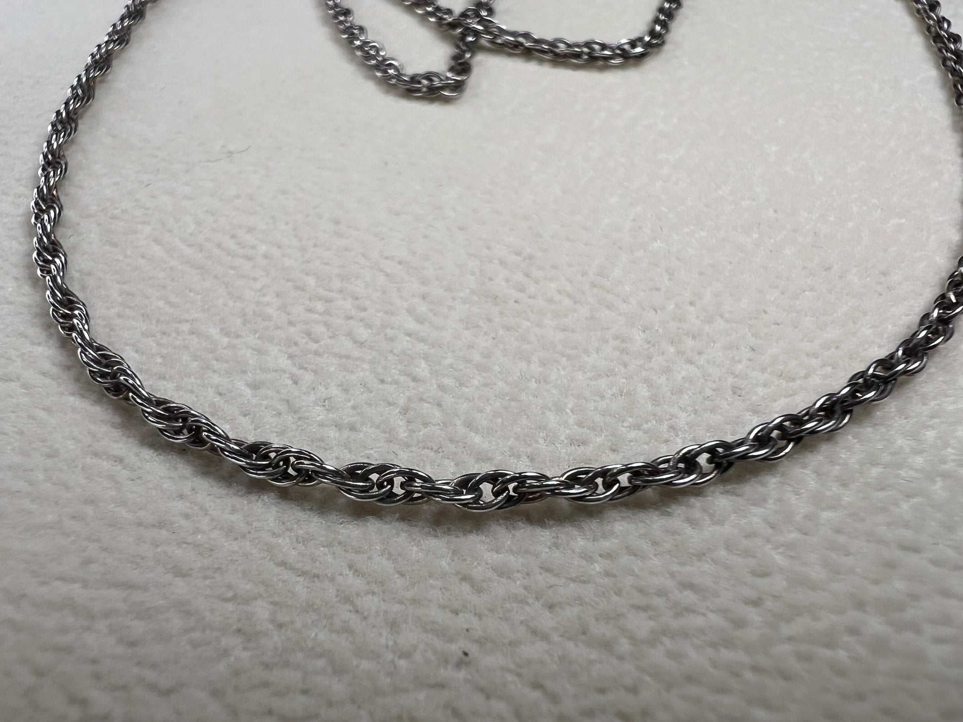 This vintage classic sterling silver 18" rope chain offers a subtle touch of timeless style. Its delicate design works beautifully on its own or as a perfect complement to one of our pendants.