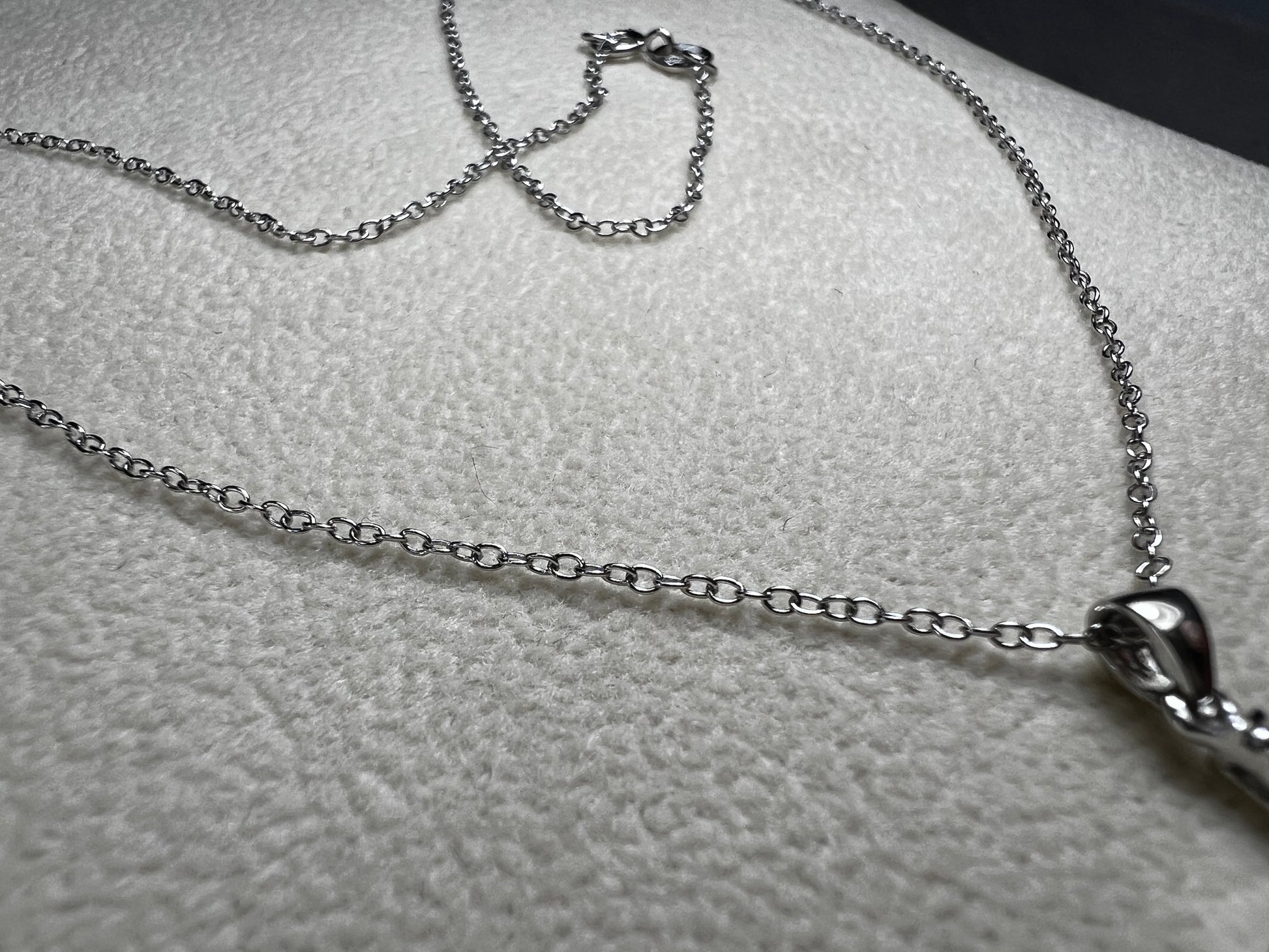This sterling silver cross pendant necklace from V3 Jewelers features a single center diamond, combining classic design with subtle sparkle. This is a meaningful accessory that adds a graceful touch to any outfit while symbolizing faith and style.