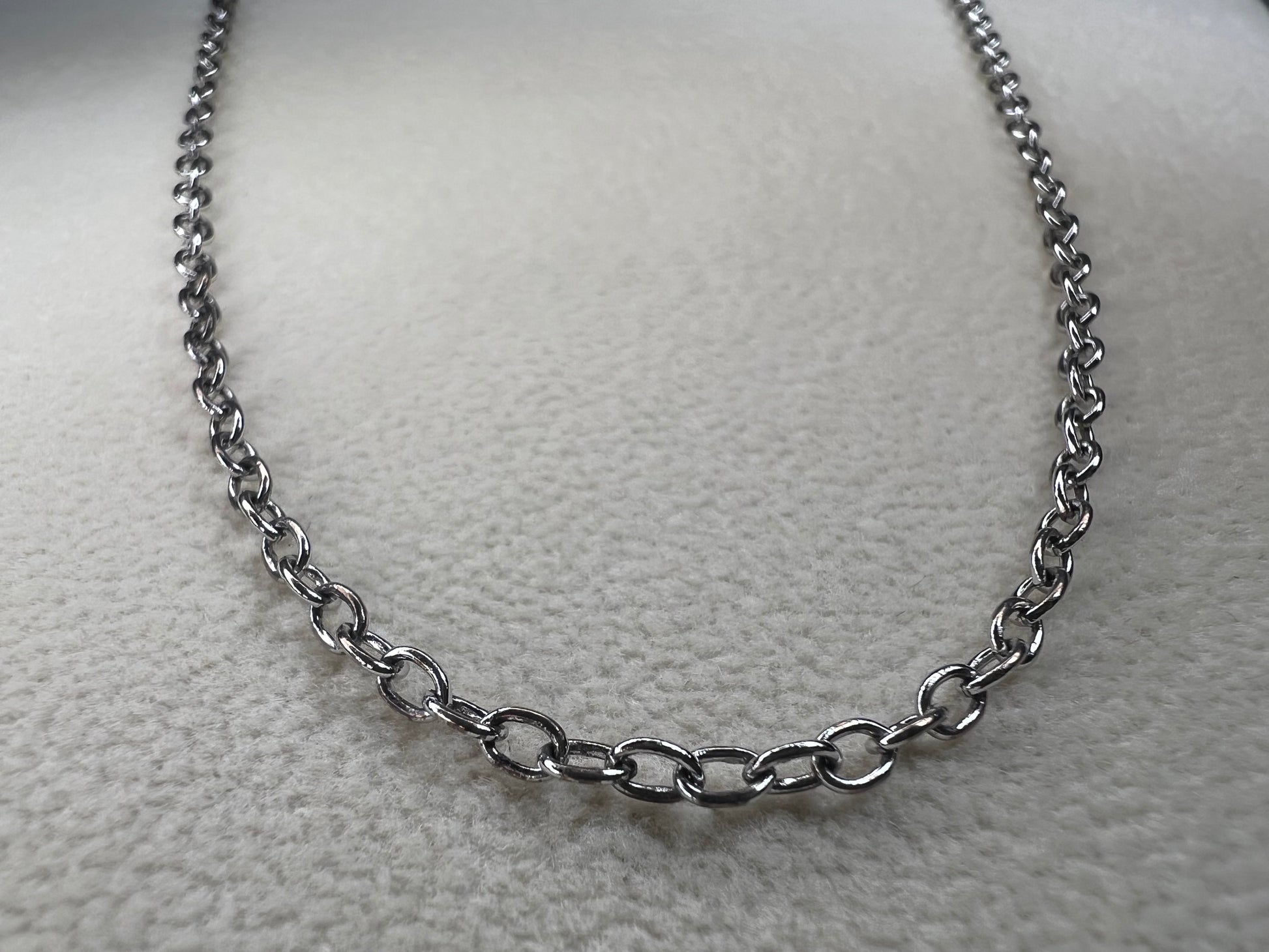 This 24" sterling silver cable chain offers a durable and elegant look that works beautifully on its own or combined with your favorite pendant. Its sturdy design ensures long-lasting wear while adding a subtle shine to your everyday style.