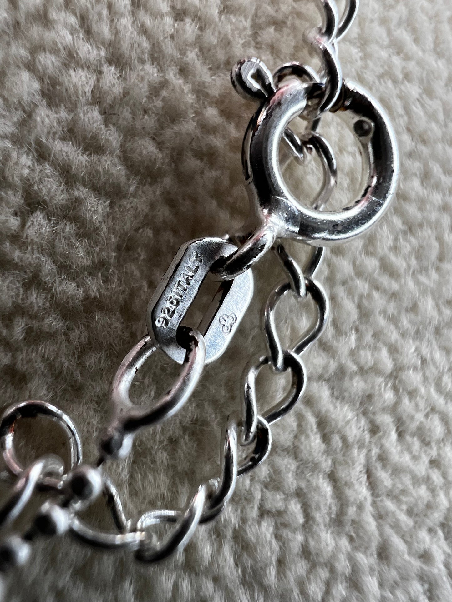 This 15" Italian sterling silver necklace features a bright finish that catches the light beautifully. Its delicate design combines tiny beads with slightly larger spaced beads, creating a simple yet striking accessory that adds subtle elegance to any outfit.