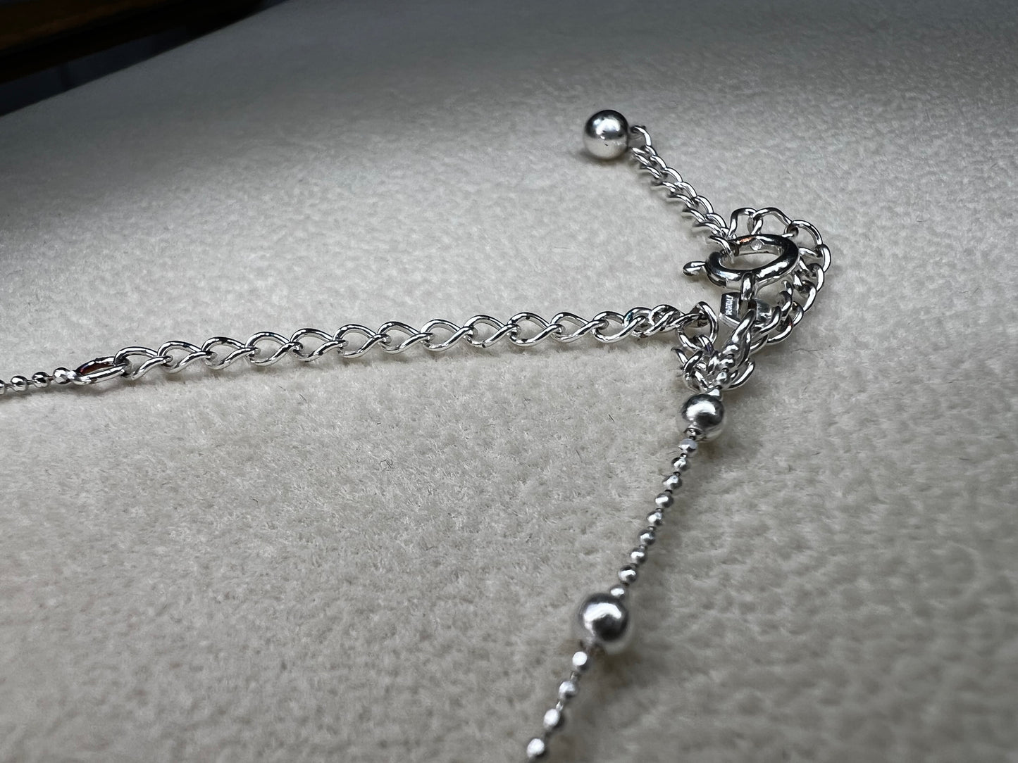 This 15" Italian sterling silver necklace features a bright finish that catches the light beautifully. Its delicate design combines tiny beads with slightly larger spaced beads, creating a simple yet striking accessory that adds subtle elegance to any outfit.