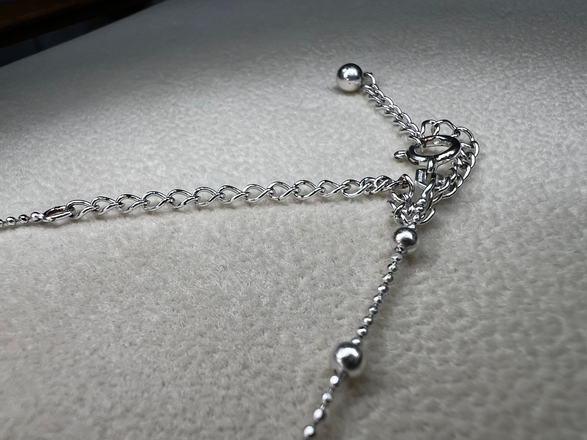 This 15" Italian sterling silver necklace features a bright finish that catches the light beautifully. Its delicate design combines tiny beads with slightly larger spaced beads, creating a simple yet striking accessory that adds subtle elegance to any outfit.
