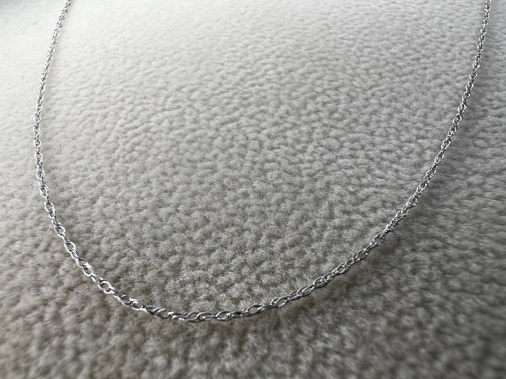 This petite 21" 14 karat white gold chain is a delicate touch of everyday elegance. It's so light that you’ll barely notice it’s there, catching the light to add subtle shine throughout your day. Perfect for layering or wearing alone.