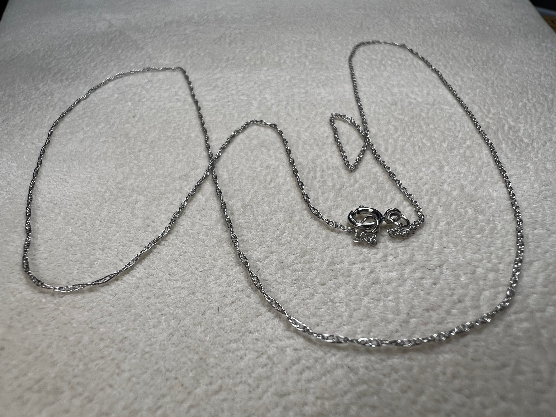 This petite 21" 14 karat white gold chain is a delicate touch of everyday elegance. It's so light that you’ll barely notice it’s there, catching the light to add subtle shine throughout your day. Perfect for layering or wearing alone.