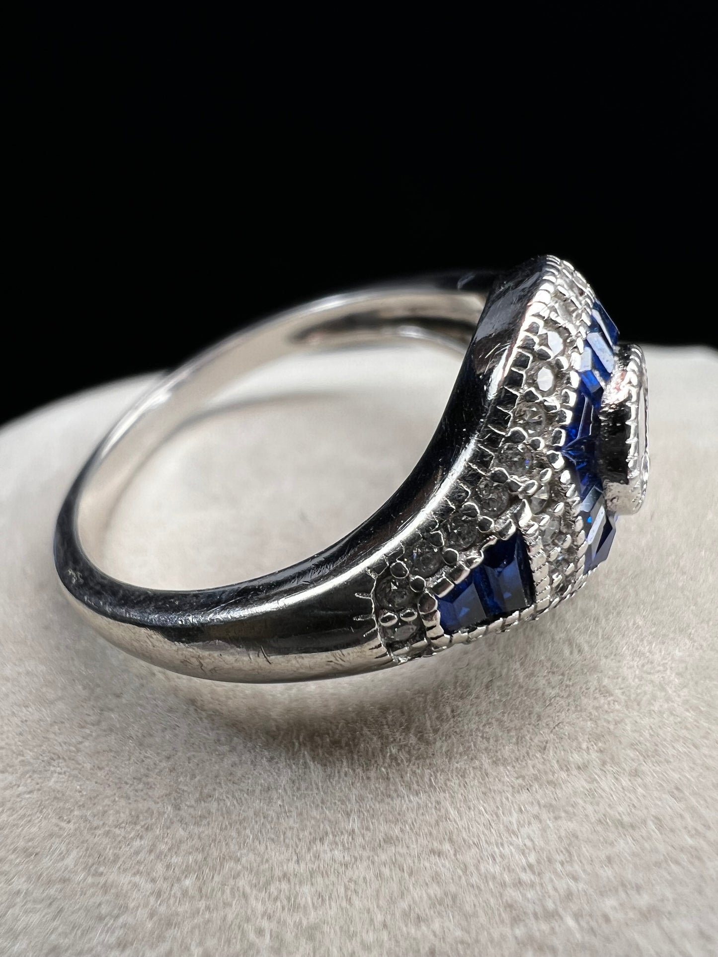 This sterling silver ring showcases exquisite Art Deco design. Featuring captivating blue spinel and quartz stones, it highlights meticulous craftsmanship and a balanced color palette, making it a standout piece for collectors and connoisseurs of fine jewelry. Signed MM.
