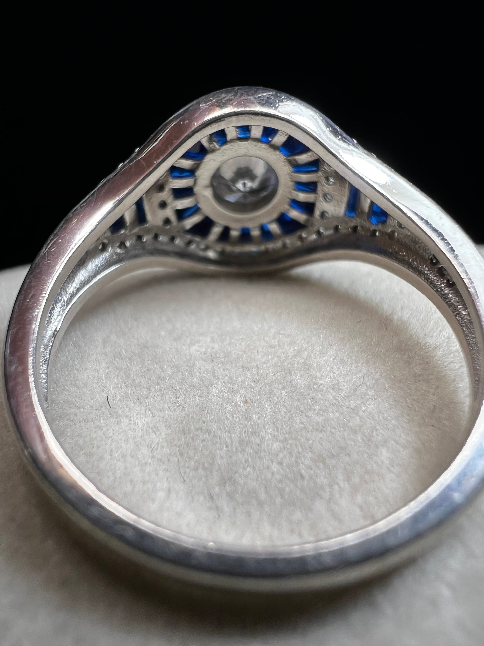This sterling silver ring showcases exquisite Art Deco design. Featuring captivating blue spinel and quartz stones, it highlights meticulous craftsmanship and a balanced color palette, making it a standout piece for collectors and connoisseurs of fine jewelry. Signed MM.