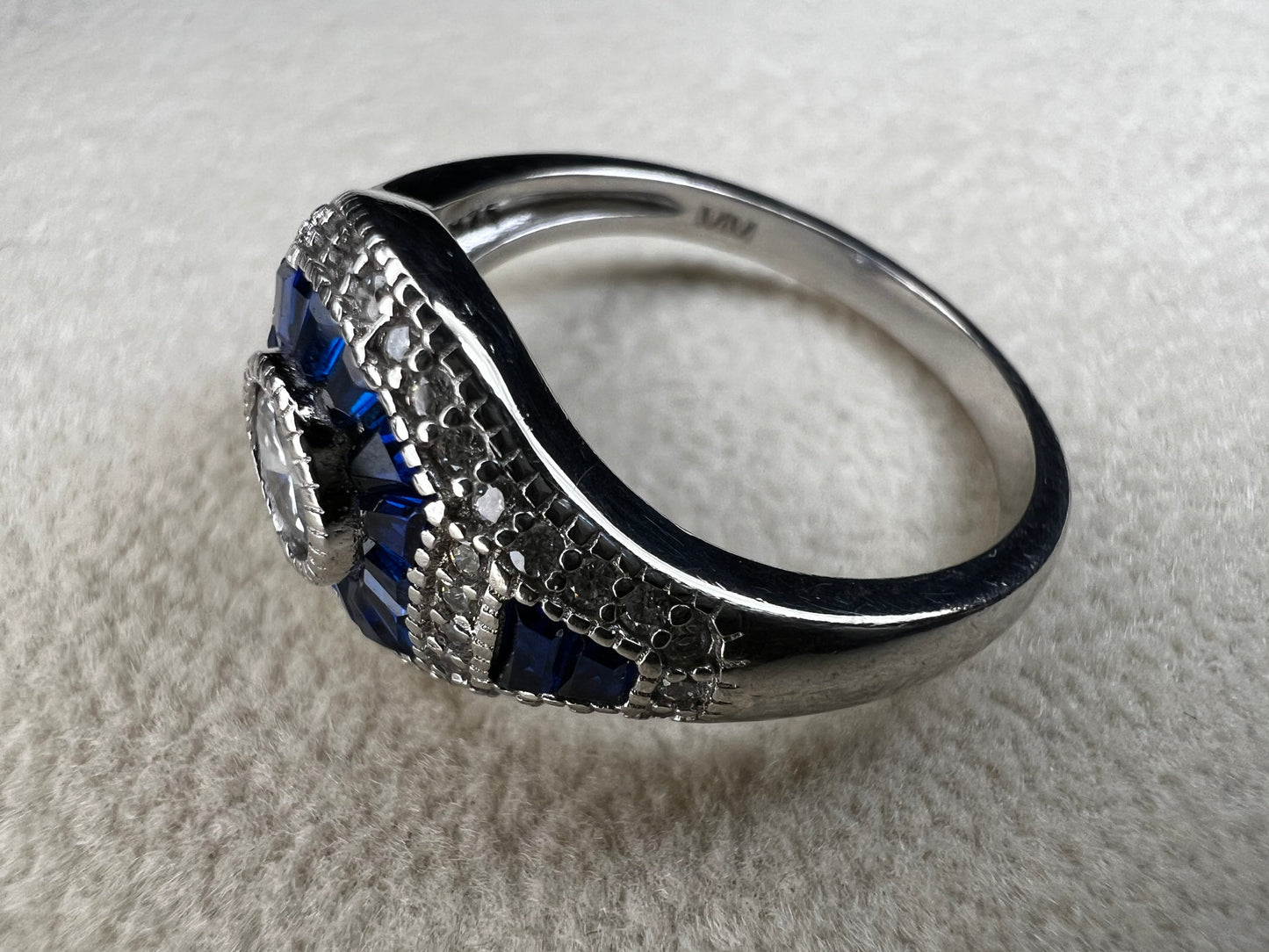 This sterling silver ring showcases exquisite Art Deco design. Featuring captivating blue spinel and quartz stones, it highlights meticulous craftsmanship and a balanced color palette, making it a standout piece for collectors and connoisseurs of fine jewelry. Signed MM.