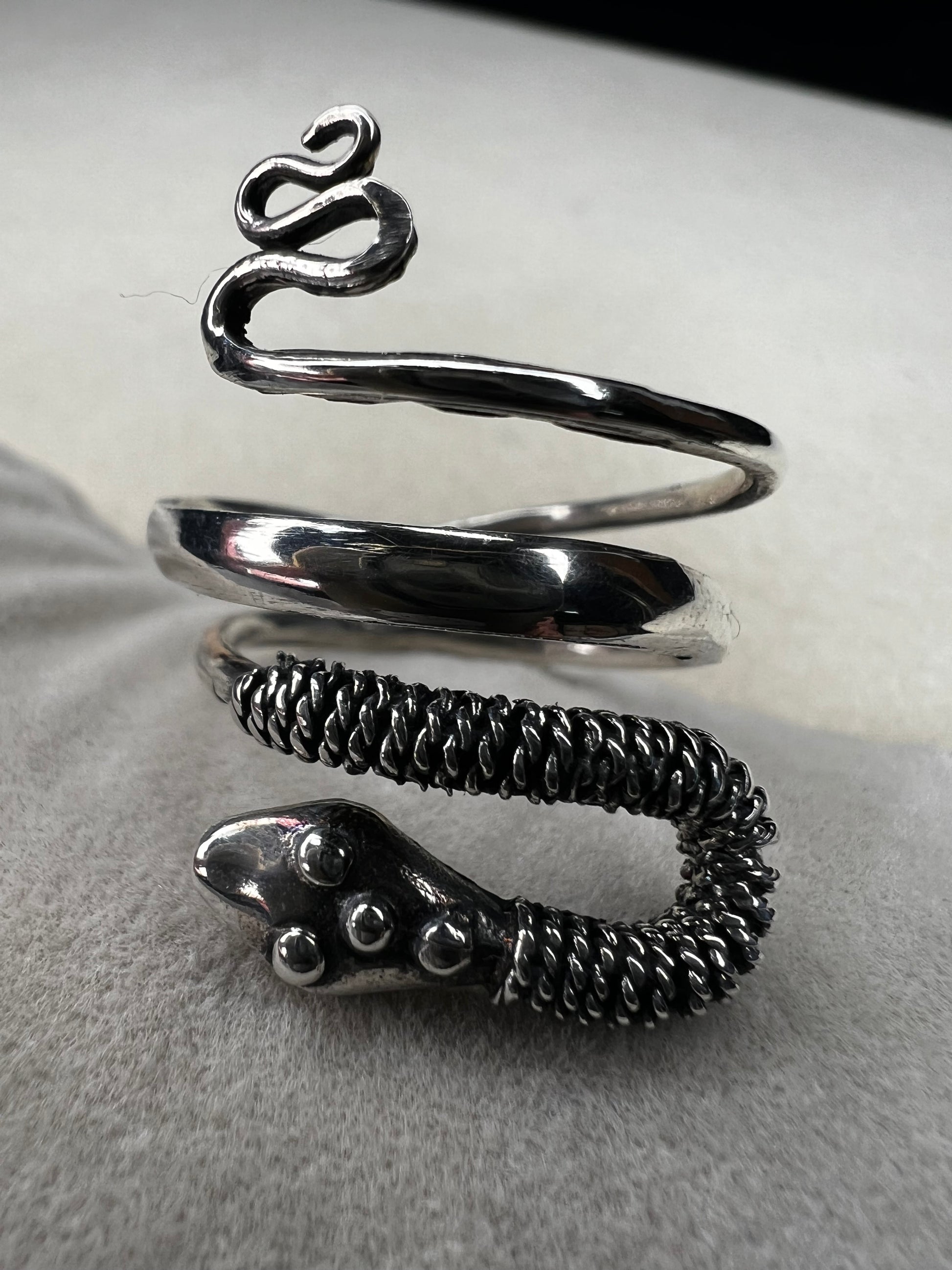 This sterling silver snake wrap ring gently coils around your finger with an open design, allowing for easy size adjustment. Its flexible fit ensures comfortable wear while adding a sleek, stylish touch to your collection.