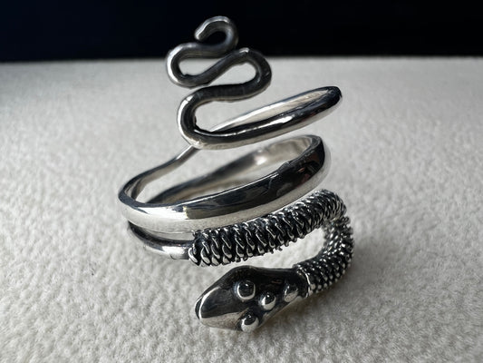 This sterling silver snake wrap ring gently coils around your finger with an open design, allowing for easy size adjustment. Its flexible fit ensures comfortable wear while adding a sleek, stylish touch to your collection.