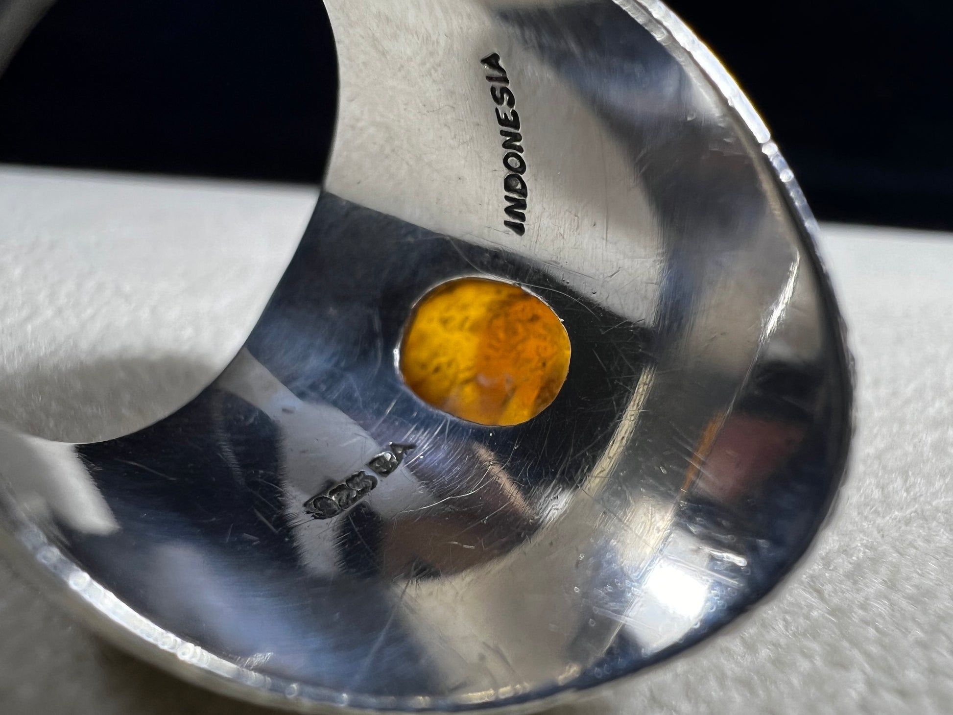 This vintage sterling silver ring features Balinese craftsmanship and a glowing amber cabochon. Made in Indonesia, it blends natural beauty with artisan elegance.