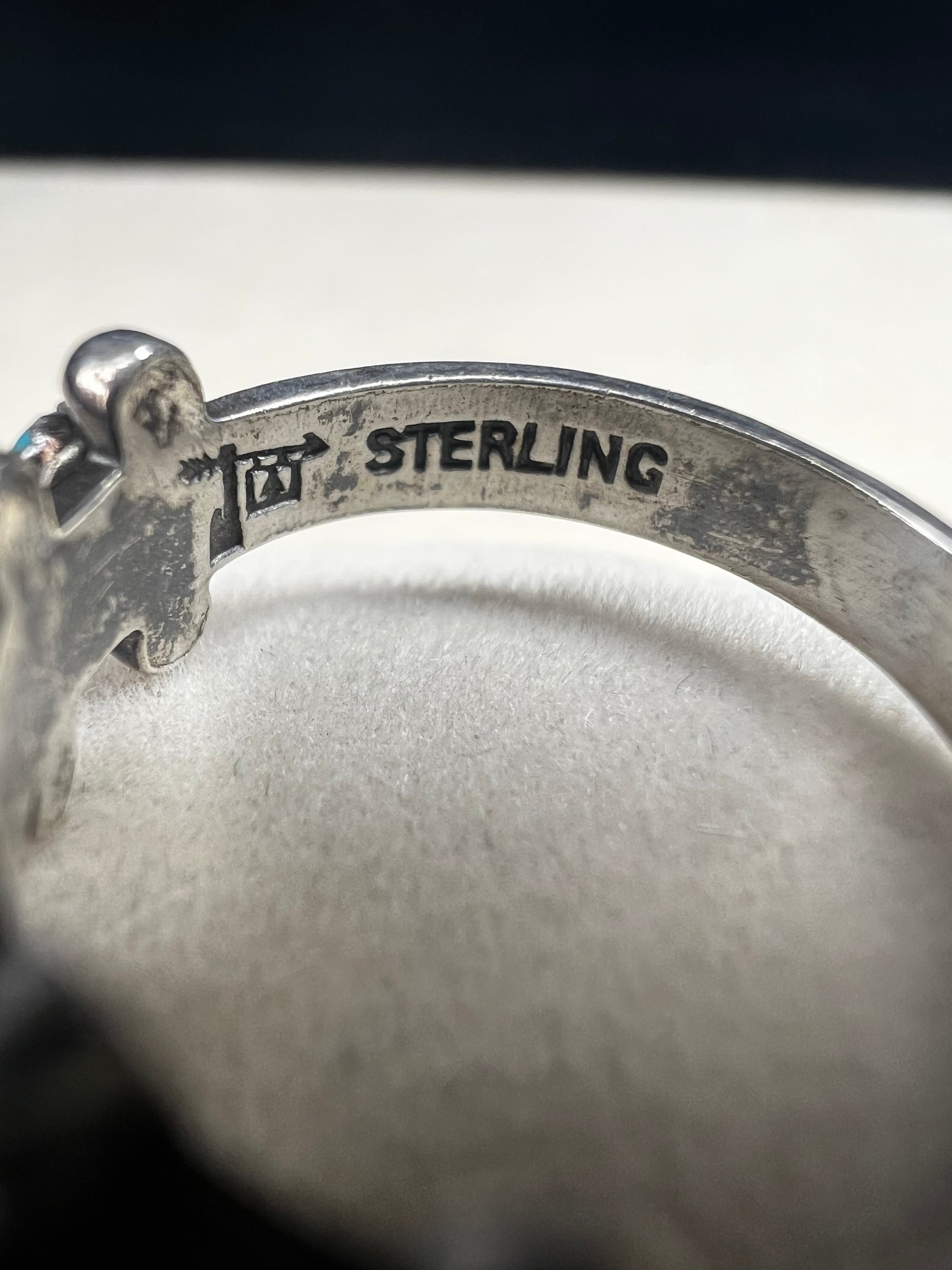 This striking vintage ring features vibrant sky-blue turquoise cabochons set in serrated bezels, accented with bold silver beadwork. Crafted in solid sterling silver, the piece carries the hallmark of Bell Trading Post, a well-known Southwestern jewelry company active from the 1930s through the 1970s.