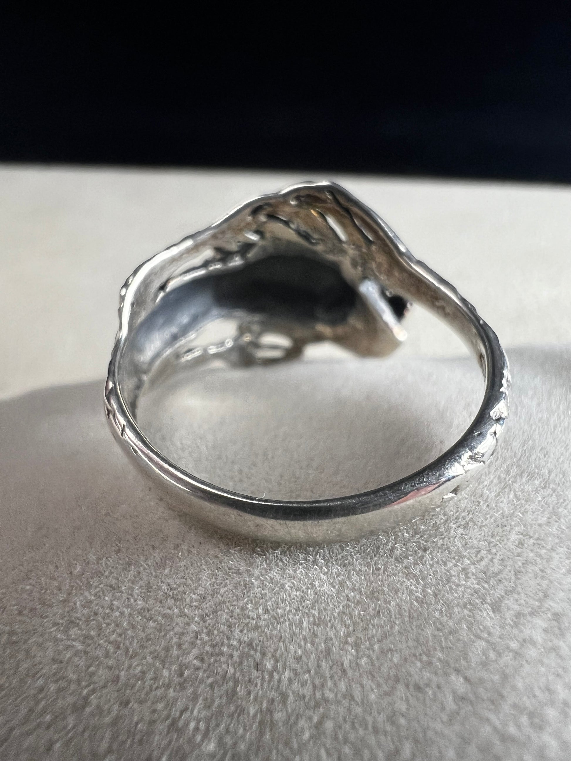 Add a touch of fierce charm to your style with this sterling silver dragon ring. Its detailed design wraps around your finger like a mythical guardian, making it the perfect statement piece.