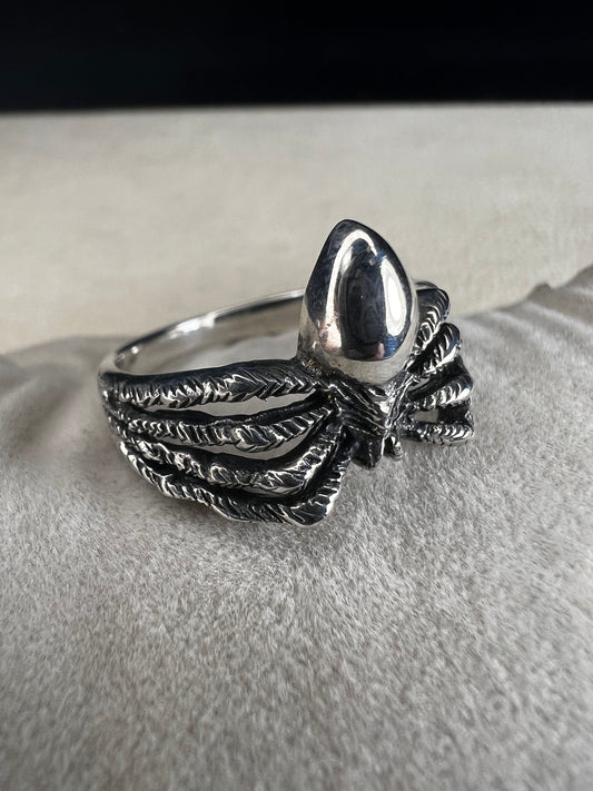 Crafted from sterling silver, this realistically detailed spider ring offers a unique and striking accessory for special occasions. Its intricate design adds a distinctive touch, making it a perfect choice for those who want to express their bold style with confidence.