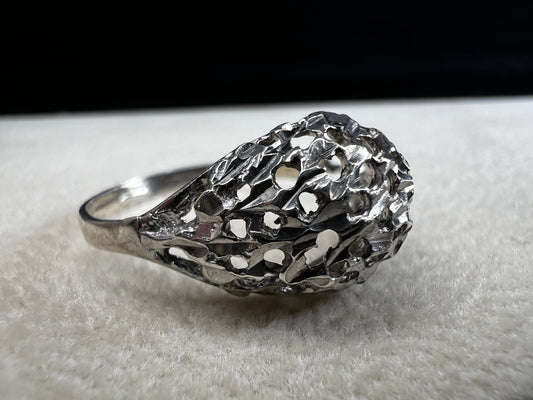 This sterling silver ring features a modern design with diamond-cut detailing that creates the timeless look of a classic nugget ring. Its open work adds elegance and depth, offering a unique style that blends contemporary flair with vintage charm for everyday wear.