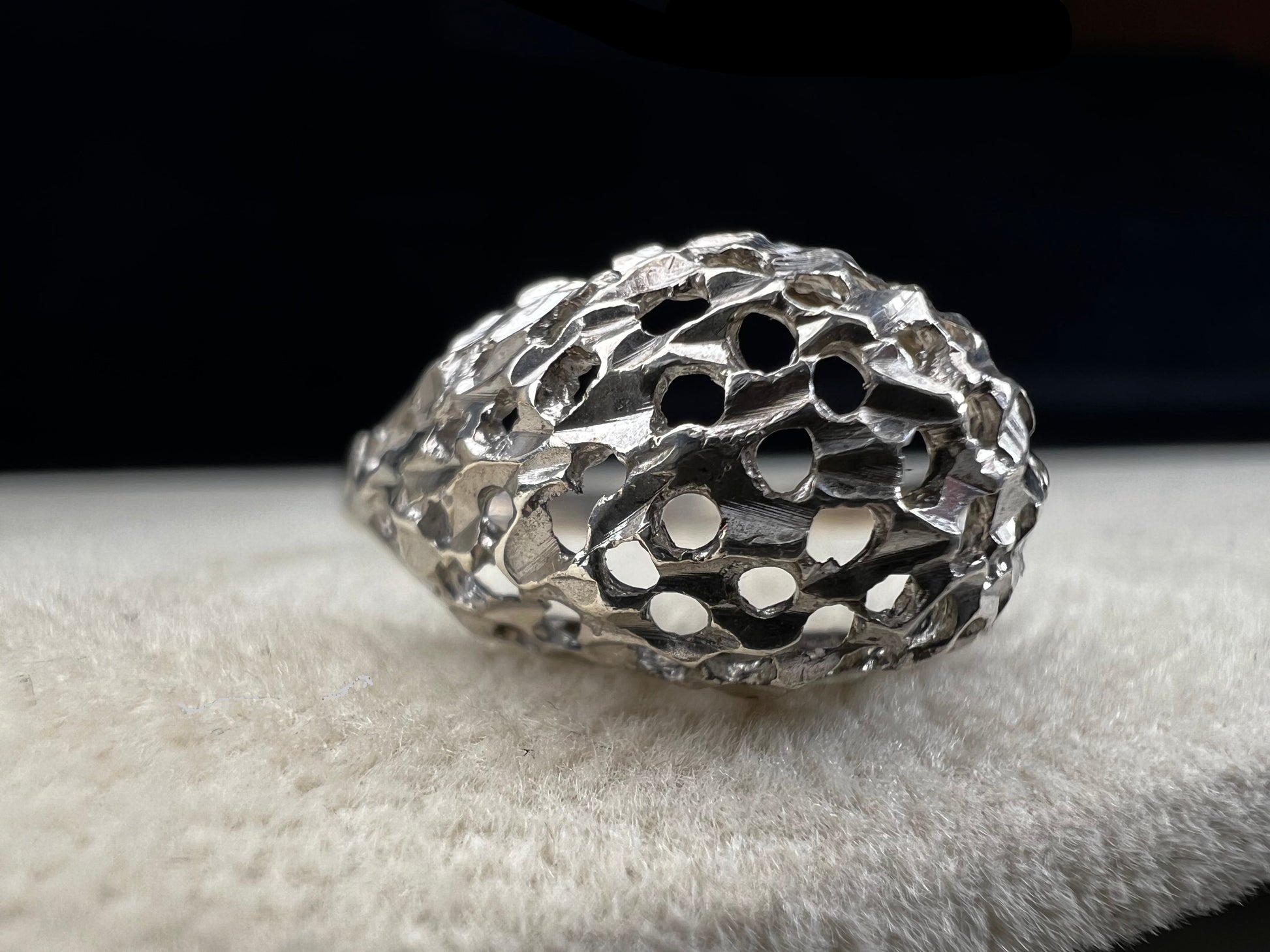 This sterling silver ring features a modern design with diamond-cut detailing that creates the timeless look of a classic nugget ring. Its open work adds elegance and depth, offering a unique style that blends contemporary flair with vintage charm for everyday wear.