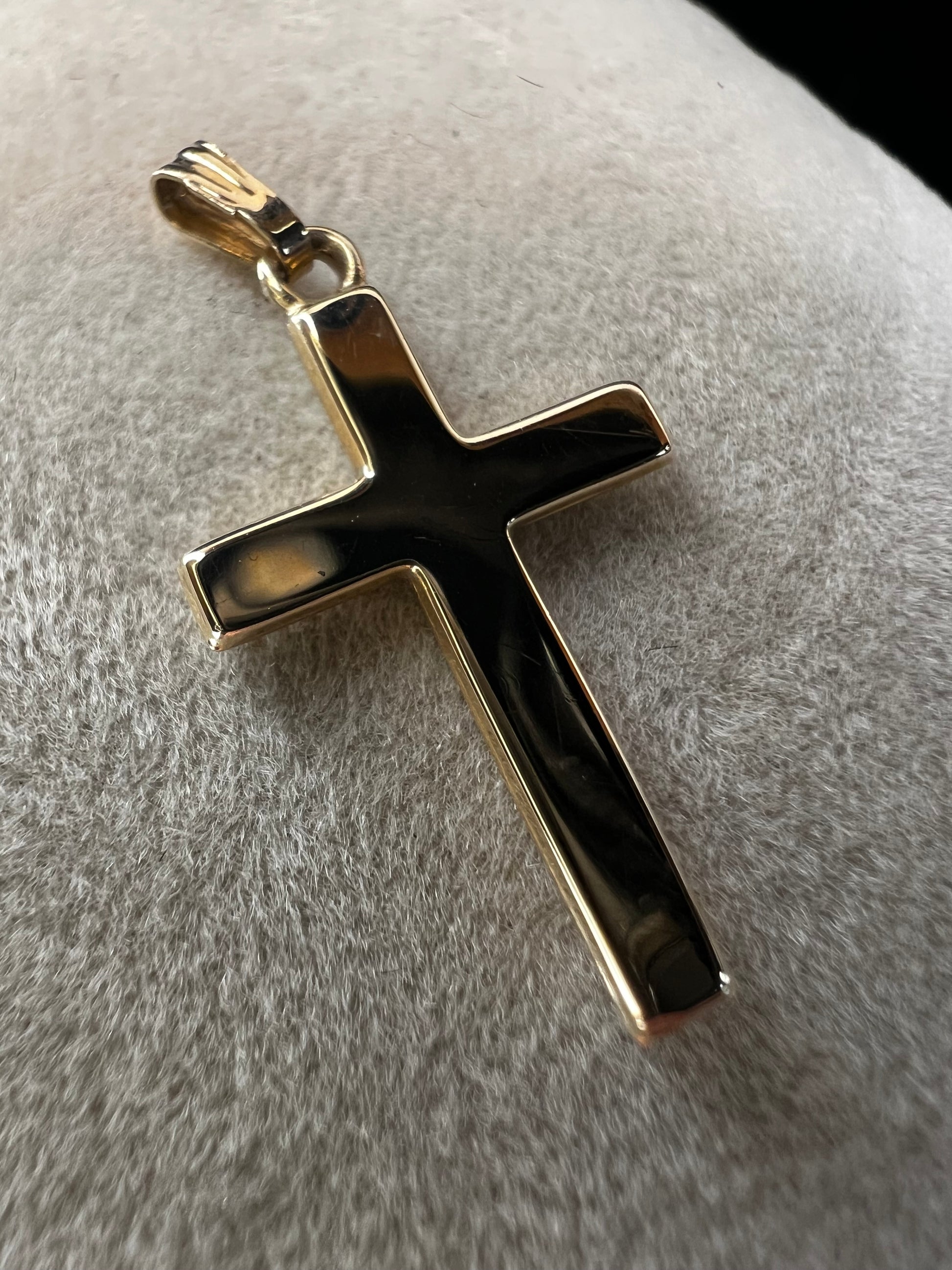 This 10 karat gold cross is a nice classic piece to pair with one of our gold chains.
