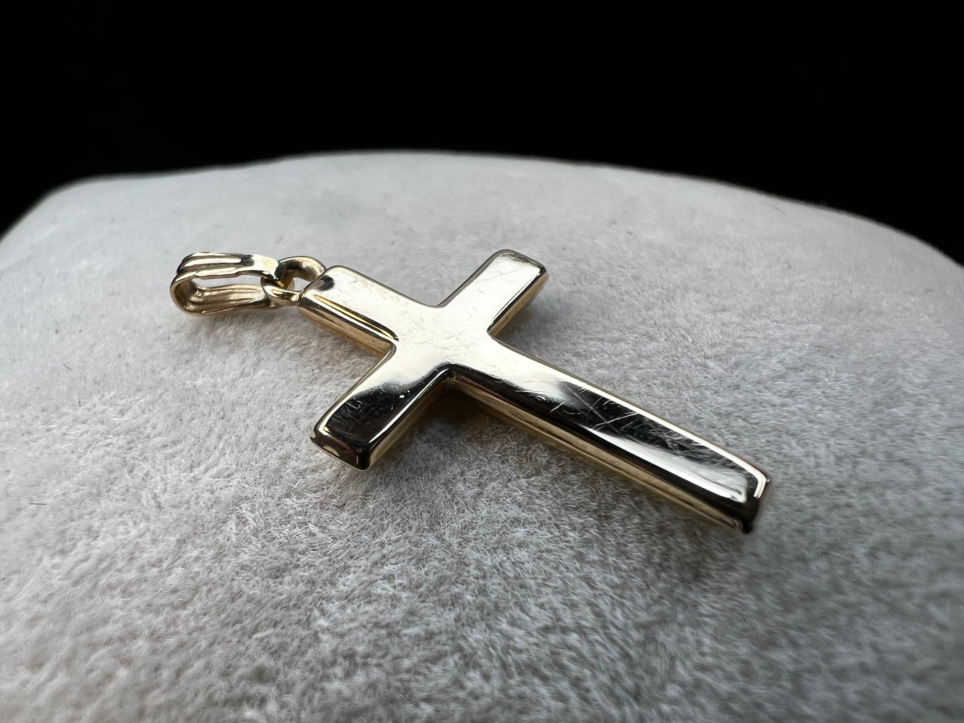 This 10 karat gold cross is a nice classic piece to pair with one of our gold chains.