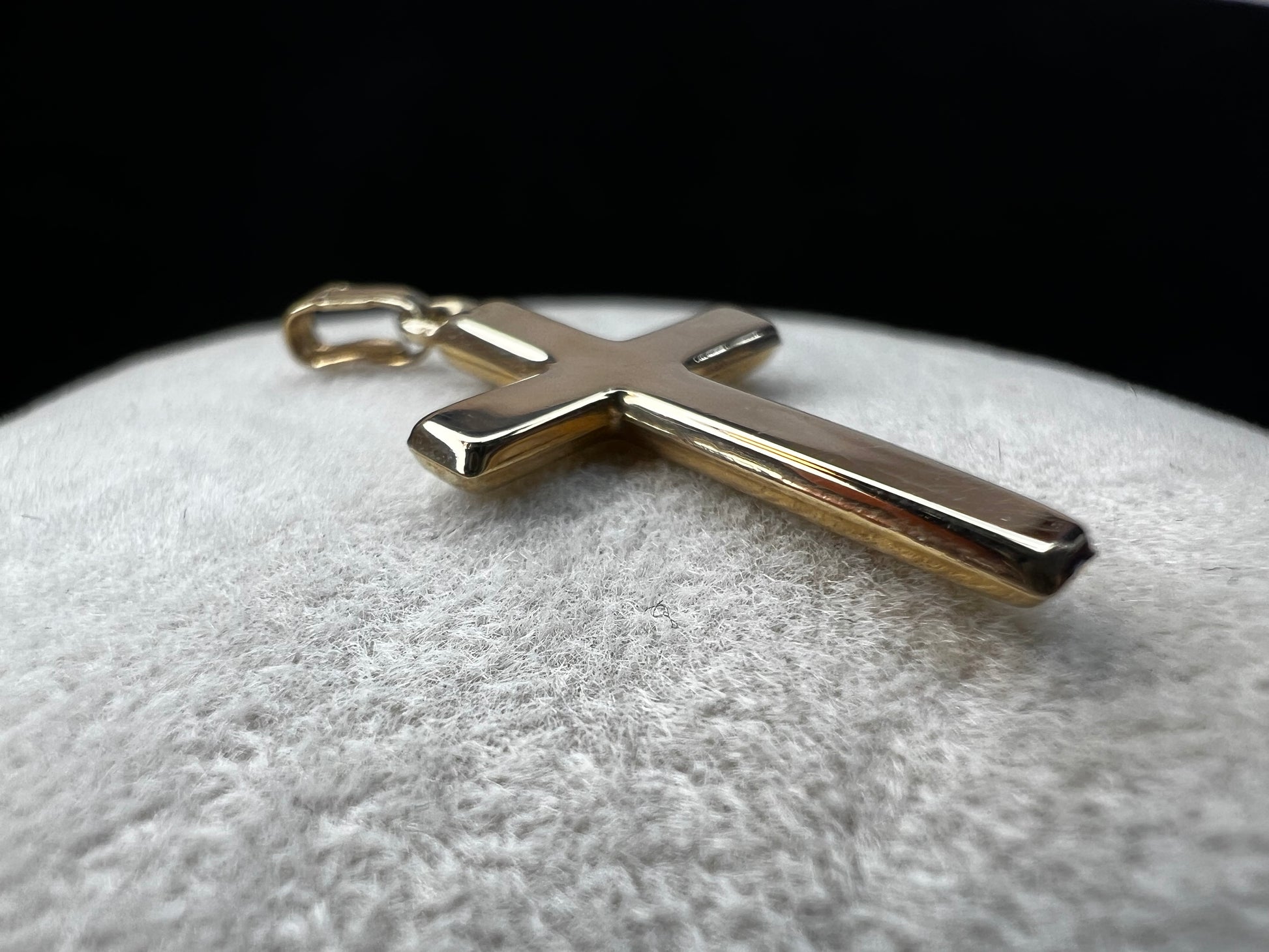 This 10 karat gold cross is a nice classic piece to pair with one of our gold chains.