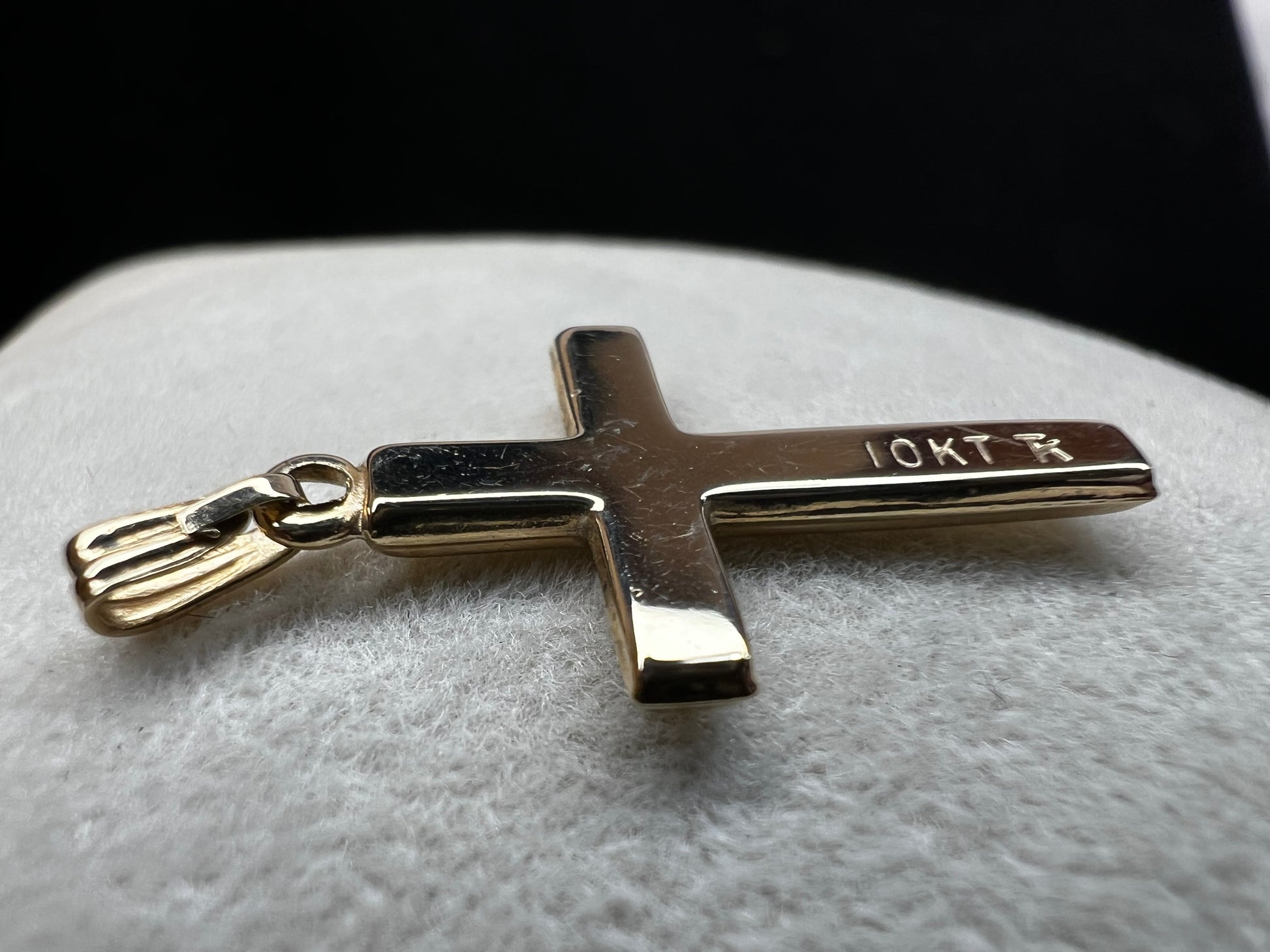 This 10 karat gold cross is a nice classic piece to pair with one of our gold chains.
