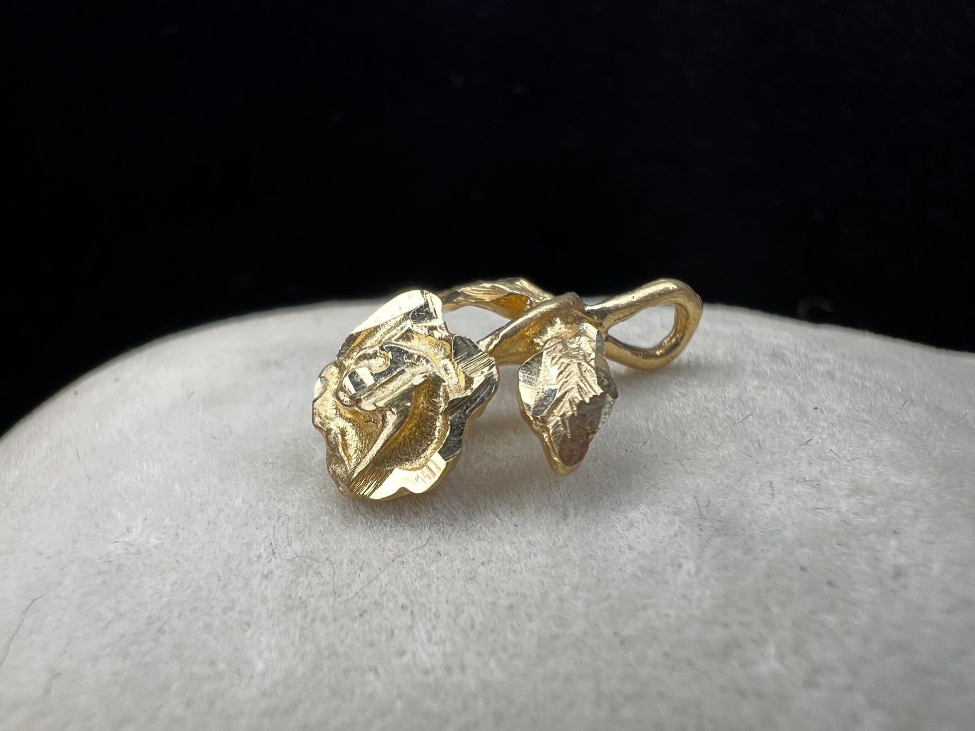 Expertly crafted from one solid piece of 14 karat gold, this pendant features a stunning flower and bail designed to last.