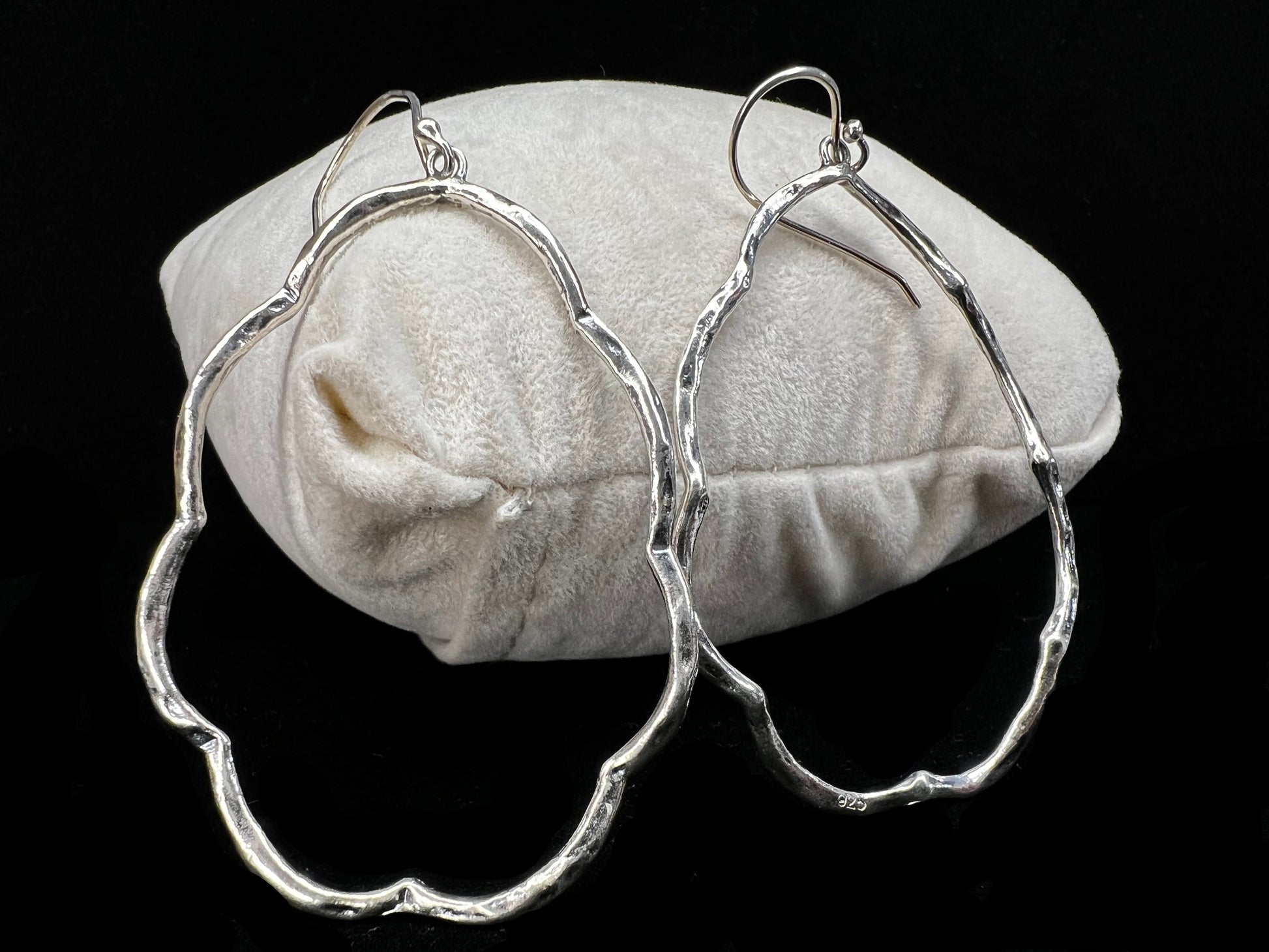 These hammered and scalloped sterling silver earrings will add a bit of flash to your outfit.