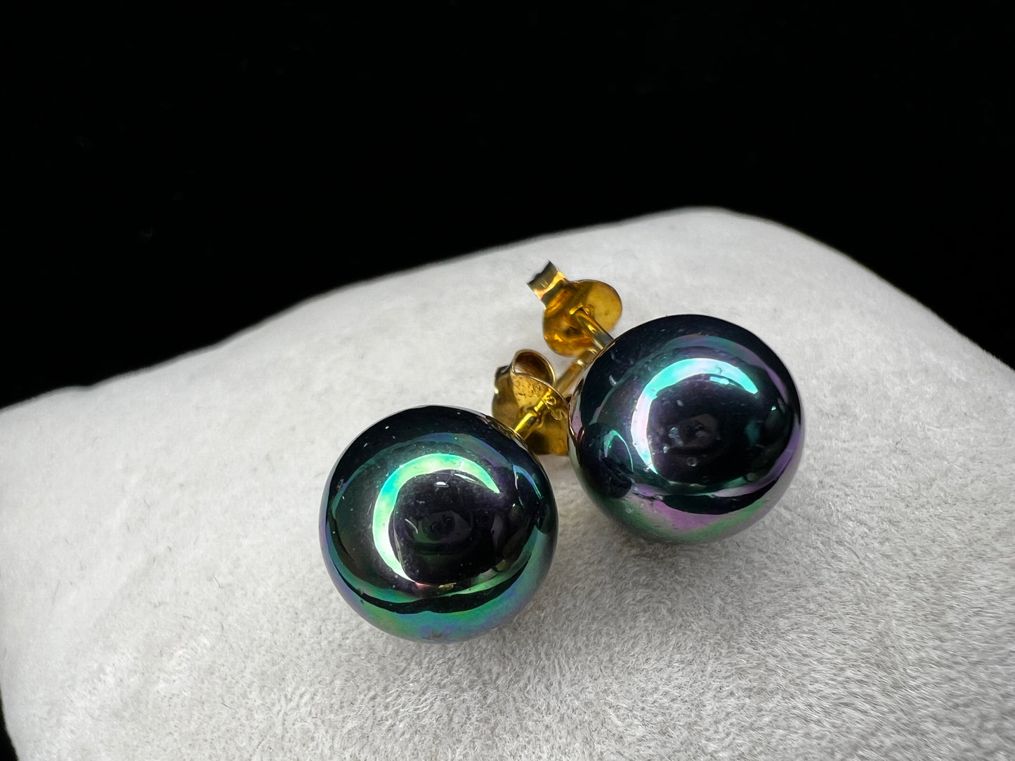 The Tahitian pearl is a great way to give a different look to a classic pair of earrings. Set with gold over sterling silver, the metallic blues and greens of these beauties will add pizzazz to any outfit.