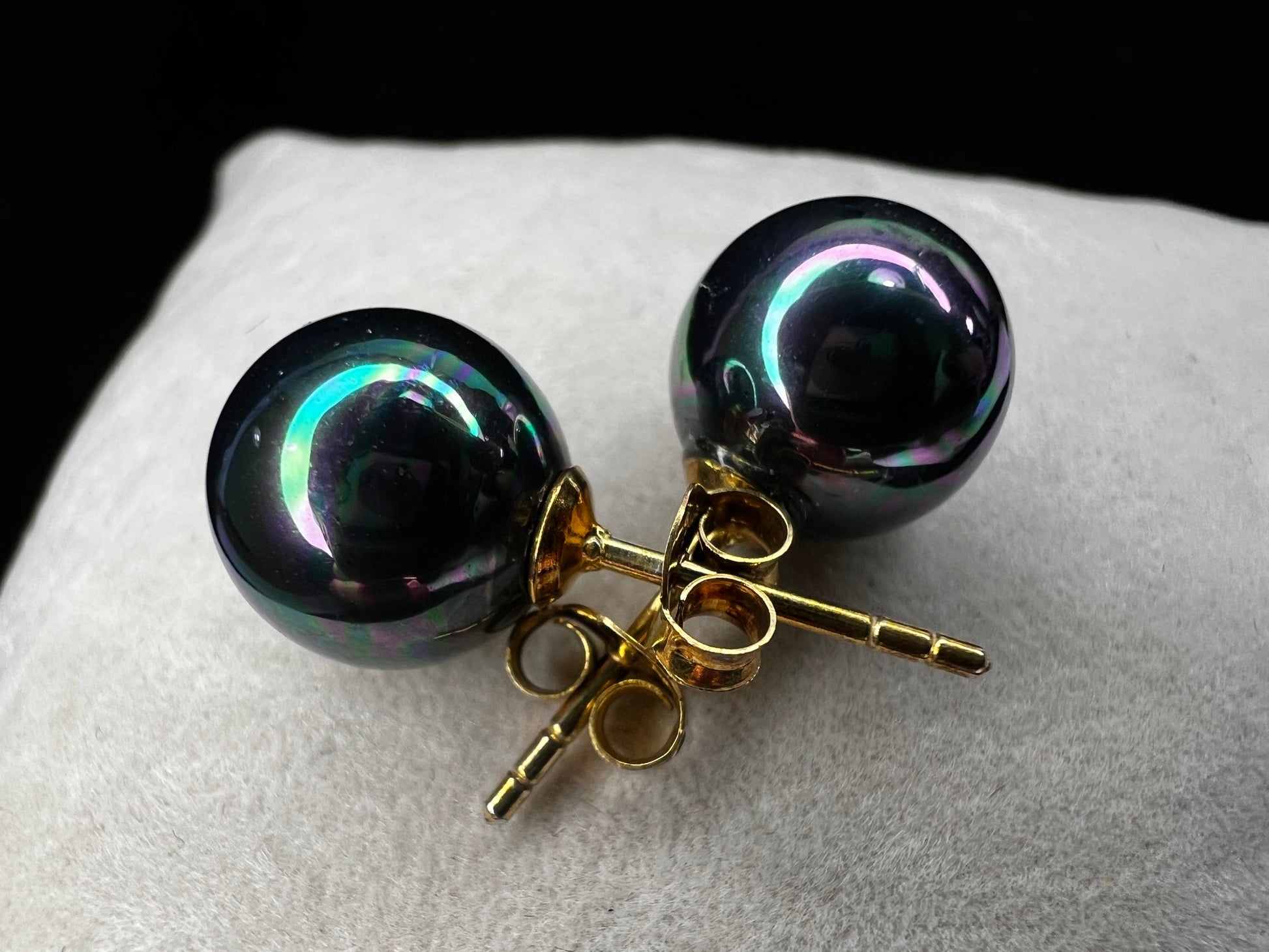 The Tahitian pearl is a great way to give a different look to a classic pair of earrings. Set with gold over sterling silver, the metallic blues and greens of these beauties will add pizzazz to any outfit.