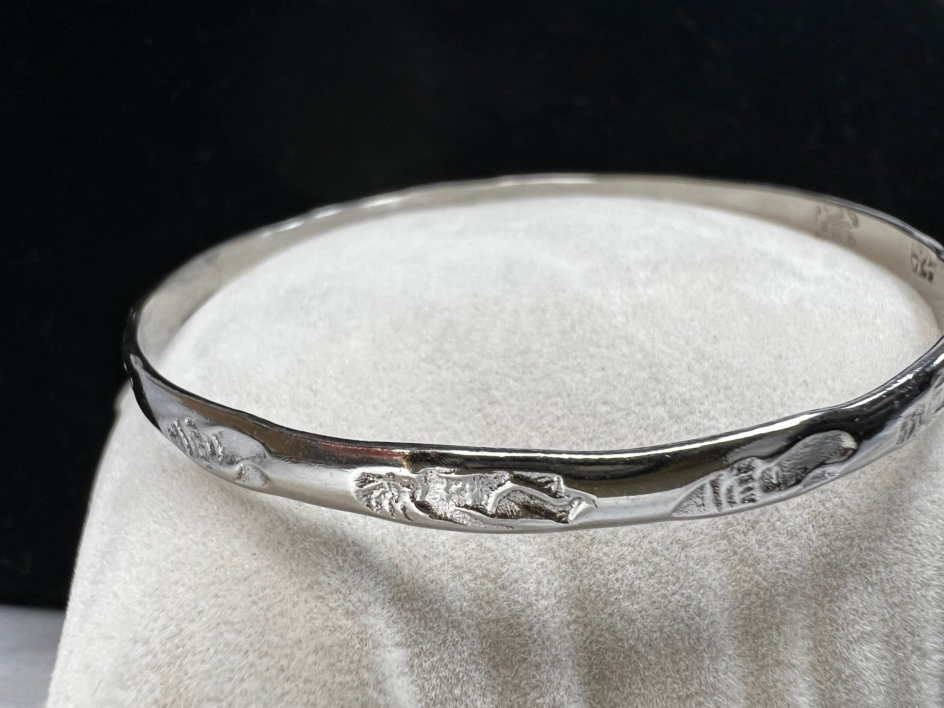 This sterling silver bangle bracelet is perfect for any outfit. It has designs around the entire outside and Mexican hallmarks on the inside.