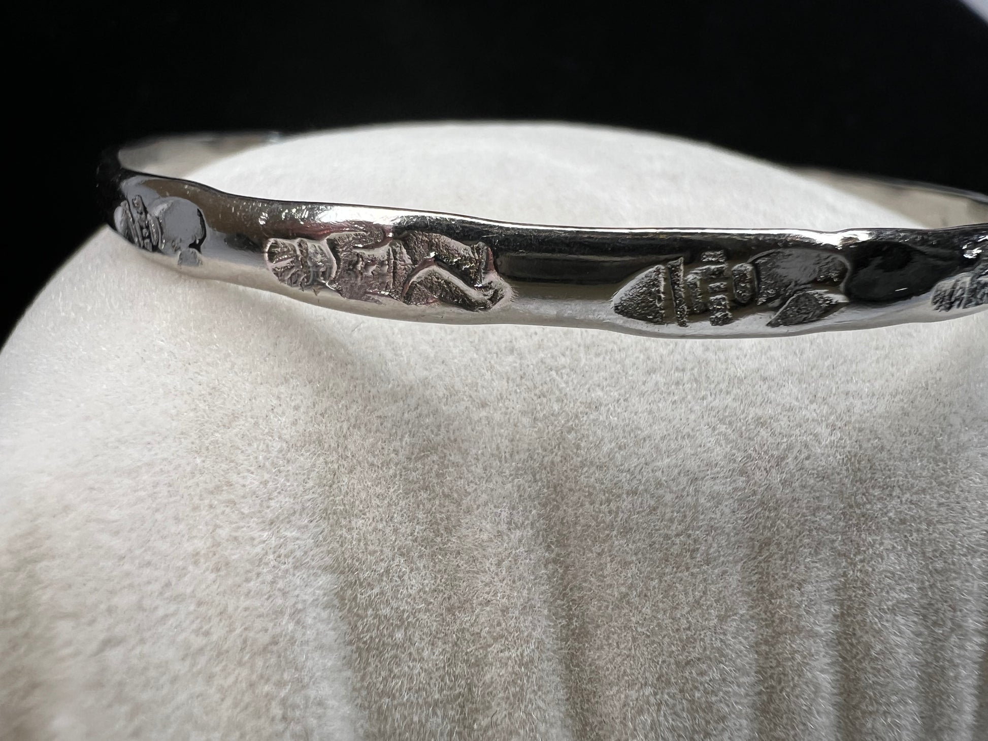 This sterling silver bangle bracelet is perfect for any outfit. It has designs around the entire outside and Mexican hallmarks on the inside.