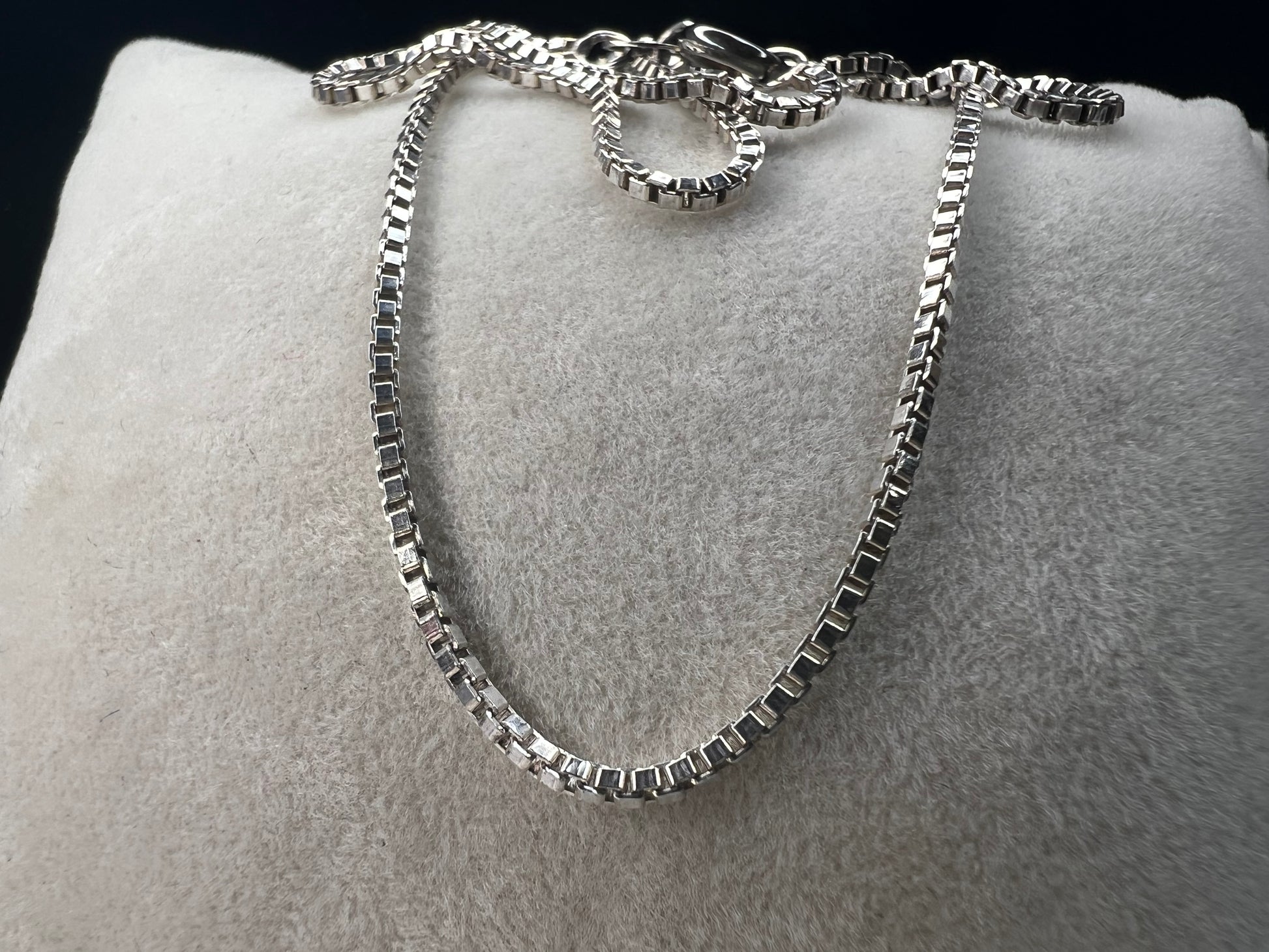 Enhance your style with our sterling silver thin box chain necklace. Perfect for day or night, this petite chain adds a touch of elegance to any outfit.