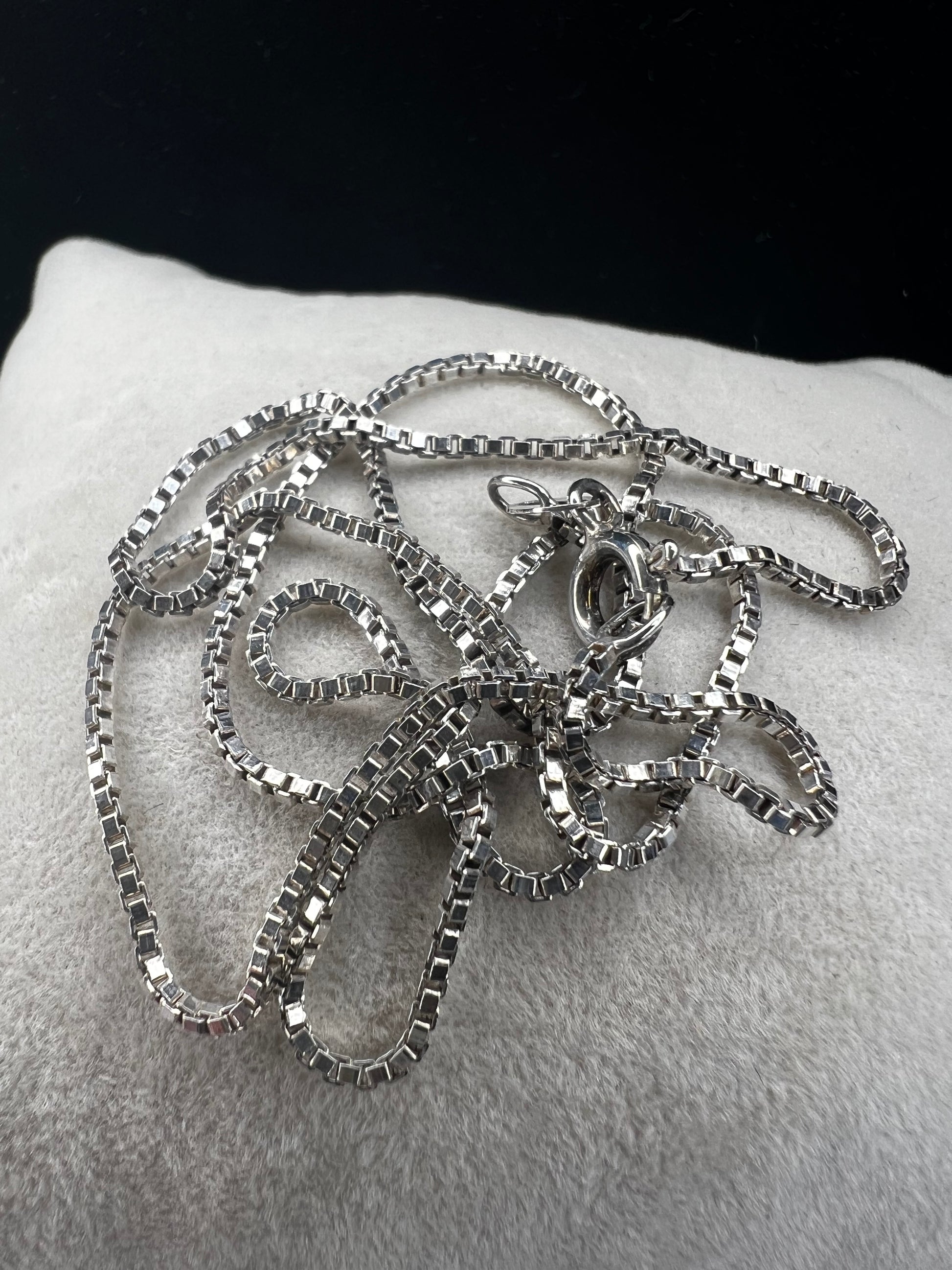 Enhance your style with our sterling silver thin box chain necklace. Perfect for day or night, this petite chain adds a touch of elegance to any outfit.