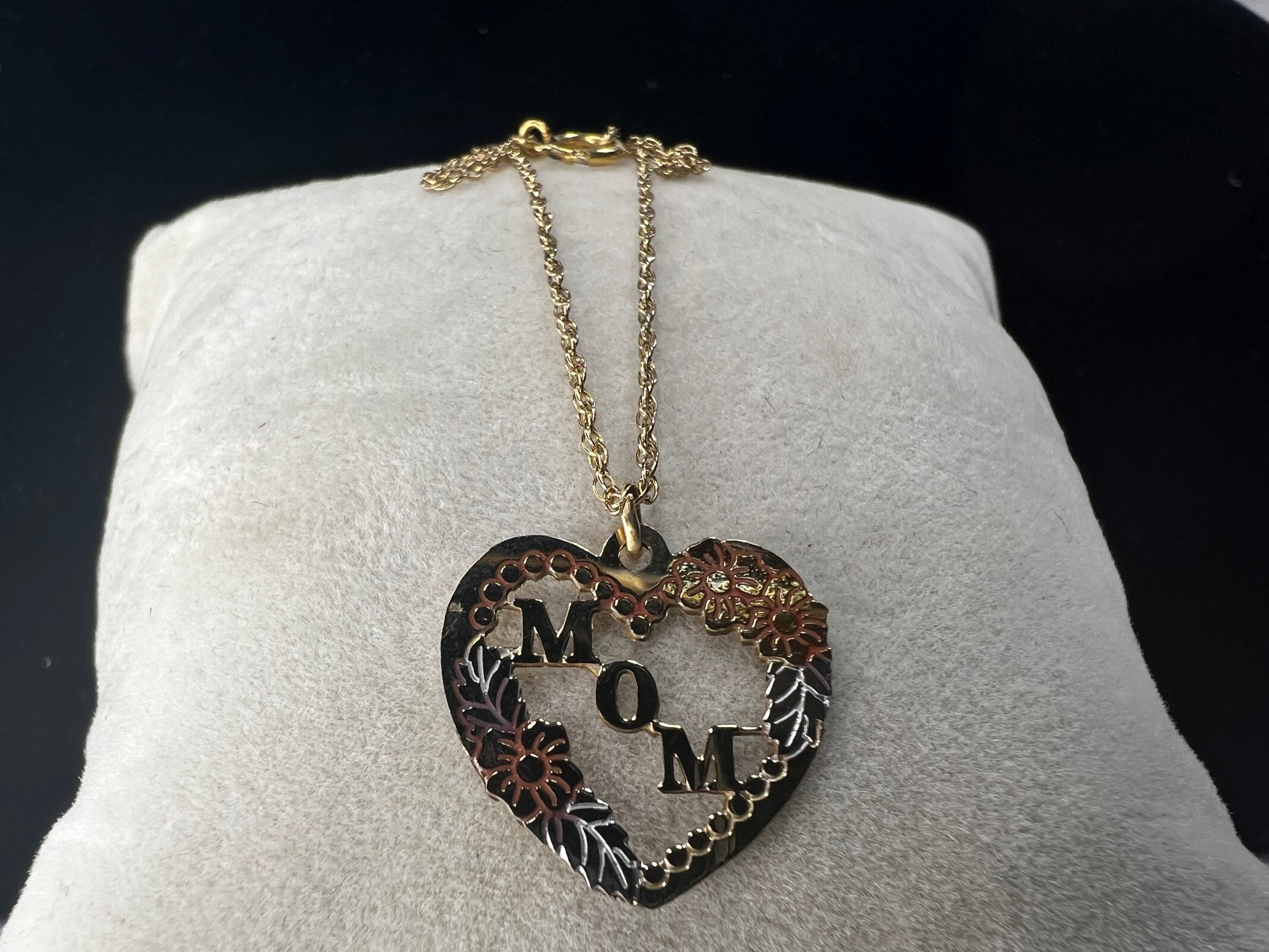 Show your mom some love with our 14 karat gold filled chain necklace and heart pendant. The chain features sturdy links with a delicate look, and the pendant has a touch of color through some enamel on the flower and silver leaves.