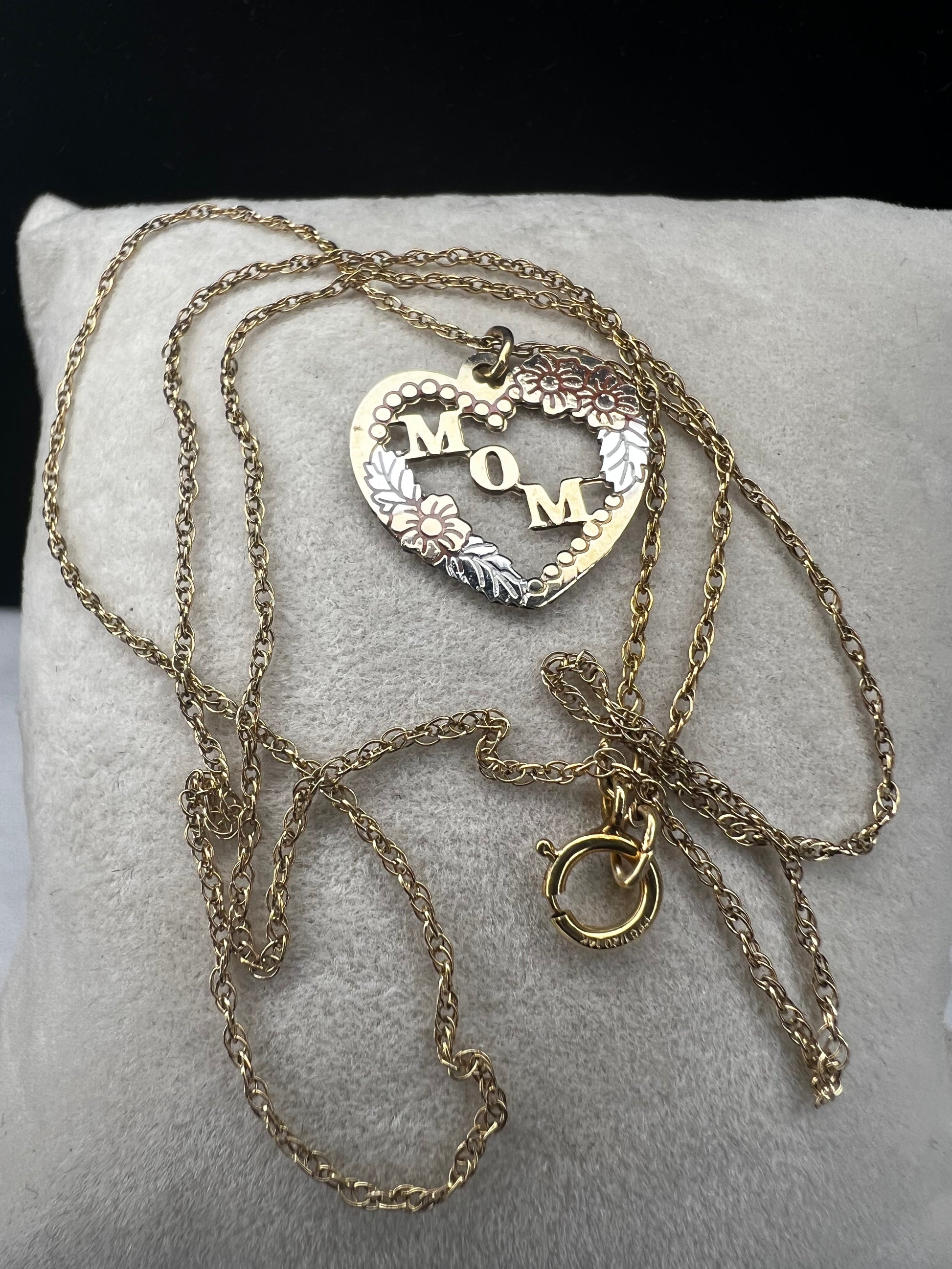 Show your mom some love with our 14 karat gold filled chain necklace and heart pendant. The chain features sturdy links with a delicate look, and the pendant has a touch of color through some enamel on the flower and silver leaves.