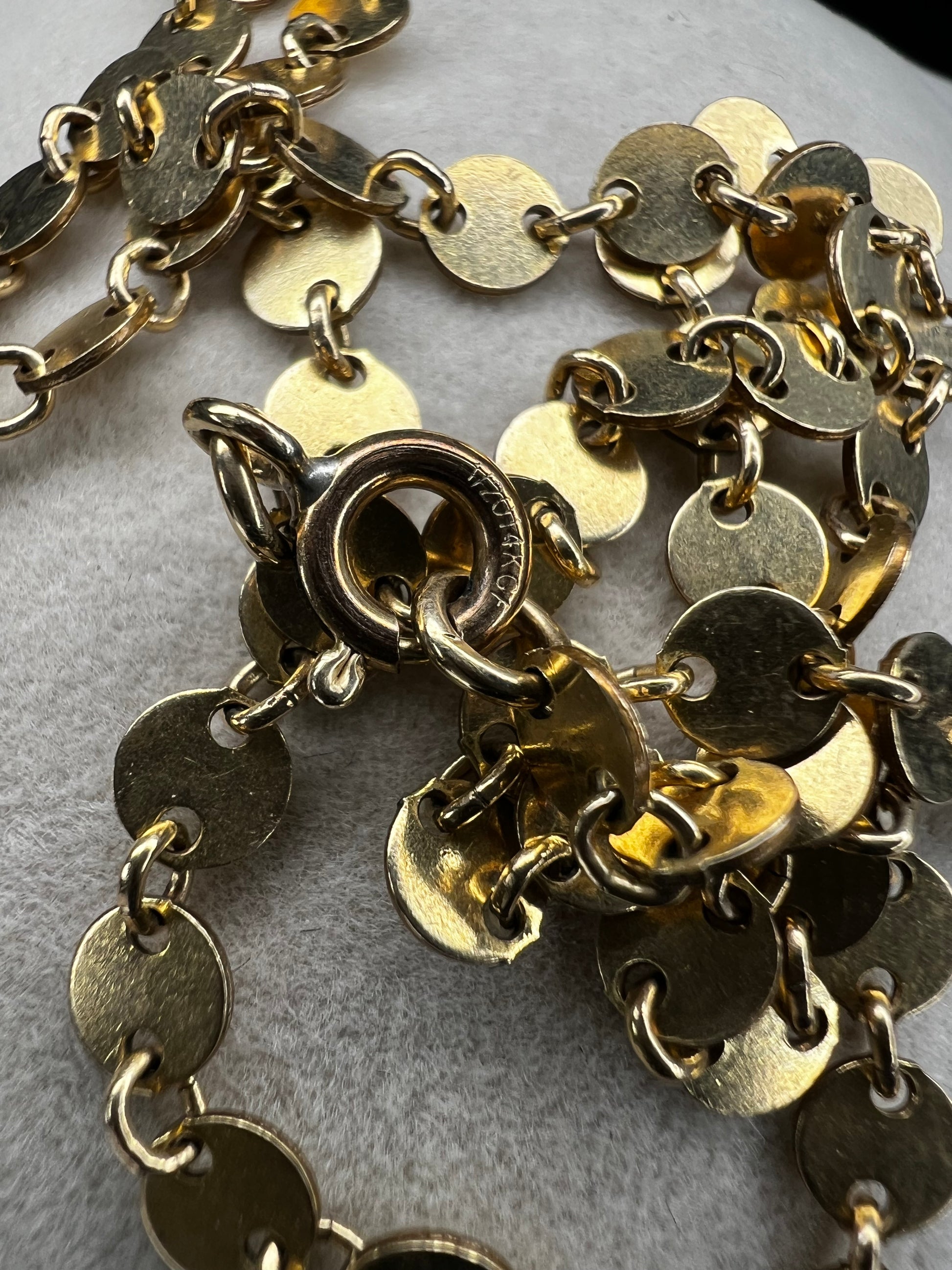 Add some sheen to your outfit with this gold filled necklace. The round flat links will make light dance around your neck.