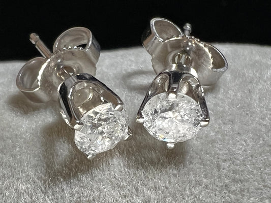 This is a unique pair of clear white galaxy diamonds set in 14 karat white gold. Galaxy diamonds have a celestial appearance due to numerous inclusions. These are natural, untreated diamonds.