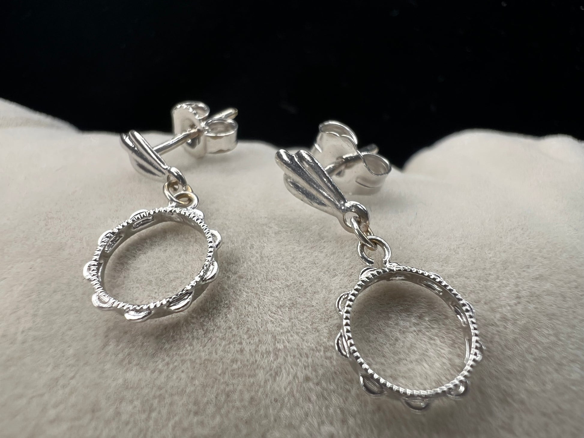 These earrings look like little tambourines. Crafted from 14 karat white gold, these would be perfect for any music lover.