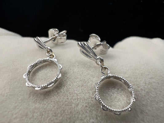 These earrings look like little tambourines. Crafted from 14 karat white gold, these would be perfect for any music lover.
