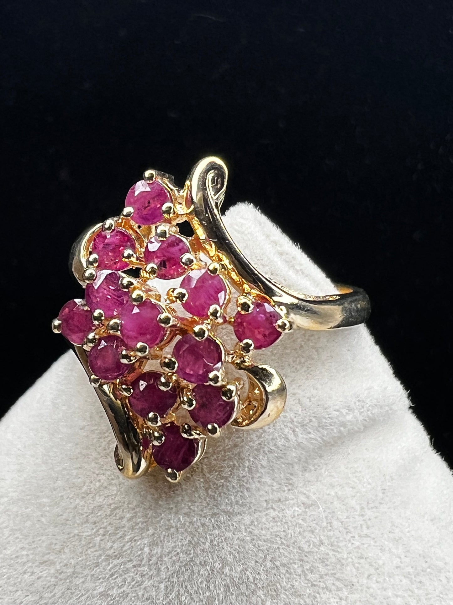 Crafted from 10 karat gold and a large cluster of rubies, this elegant cocktail ring will make an impression.