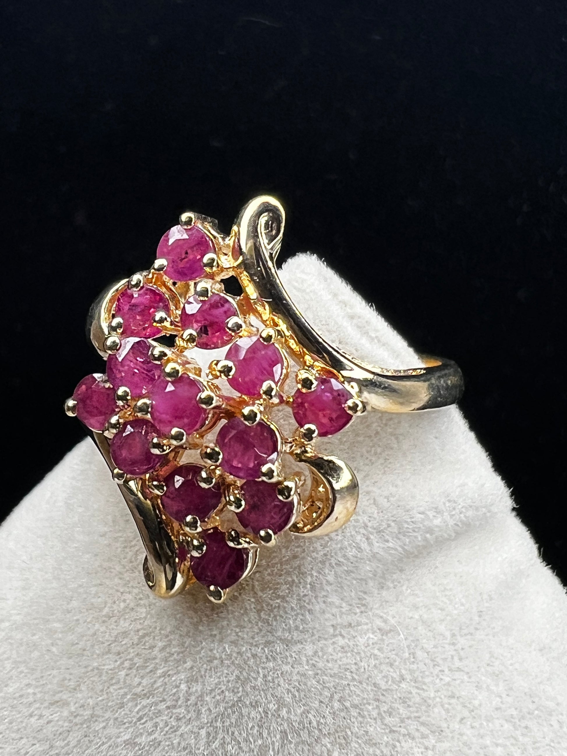 Crafted from 10 karat gold and a large cluster of rubies, this elegant cocktail ring will make an impression.
