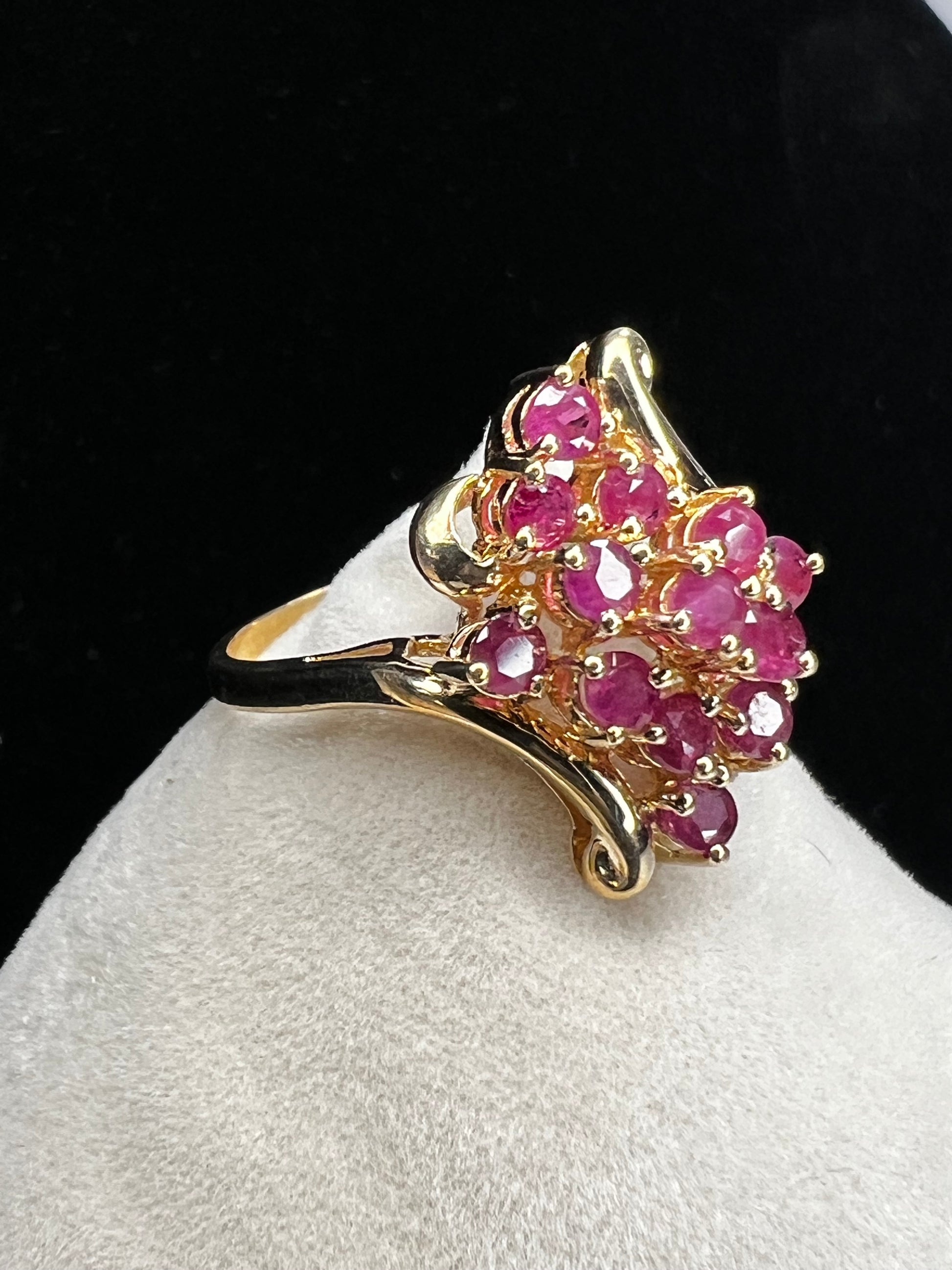 Crafted from 10 karat gold and a large cluster of rubies, this elegant cocktail ring will make an impression.
