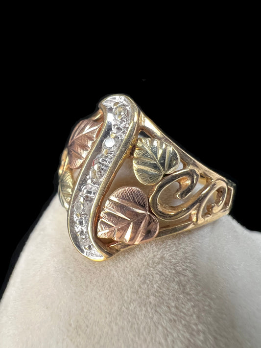 This ring features the signature look of Black Hills gold offered by Coleman Co. Made from 10 karat gold, it features a strip of small diamonds down the center.
