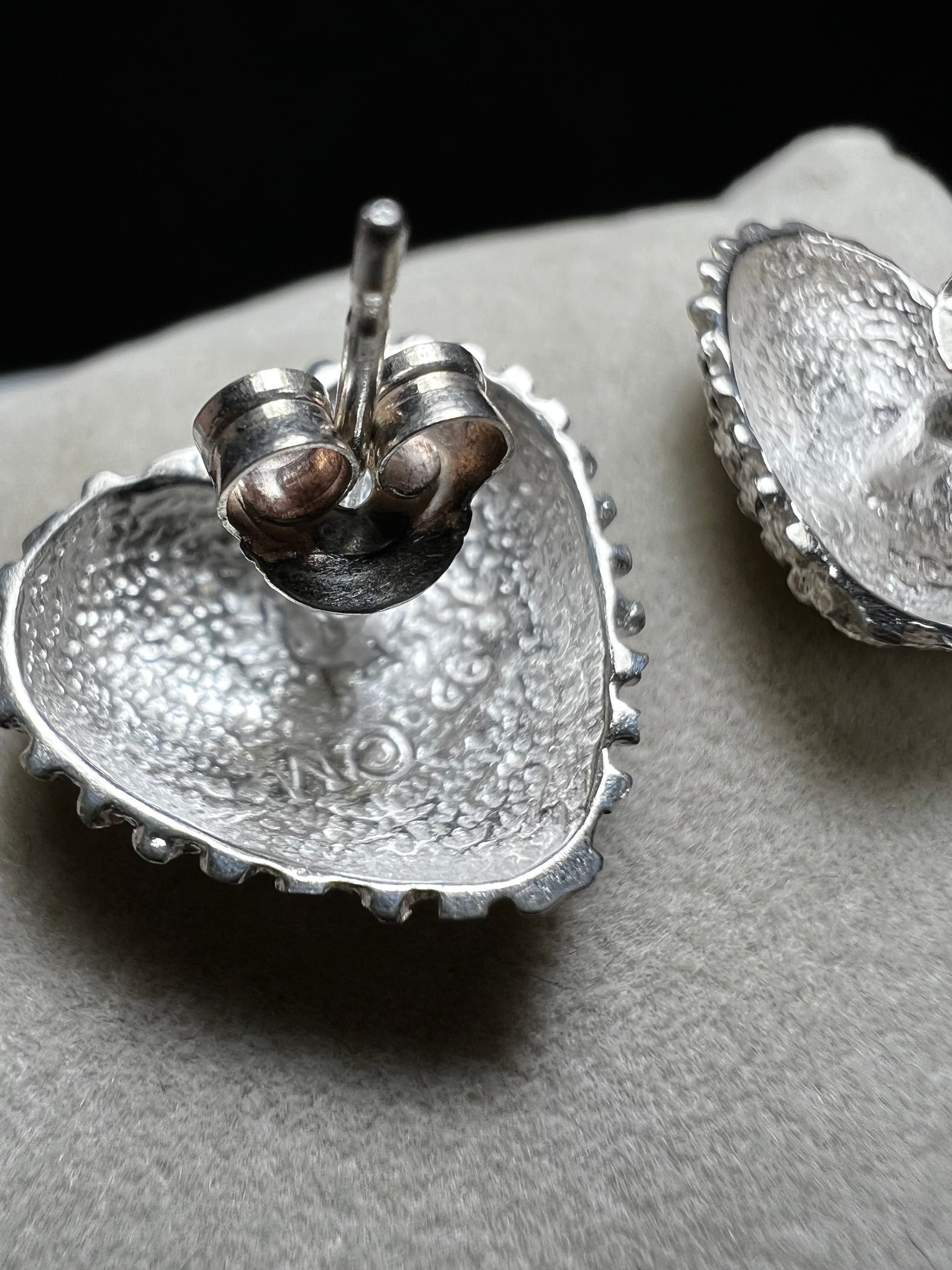 These bold heart-shaped sterling silver earrings are designed to look like a cluster of diamonds. It's a stunning look that will catch the light from every angle.