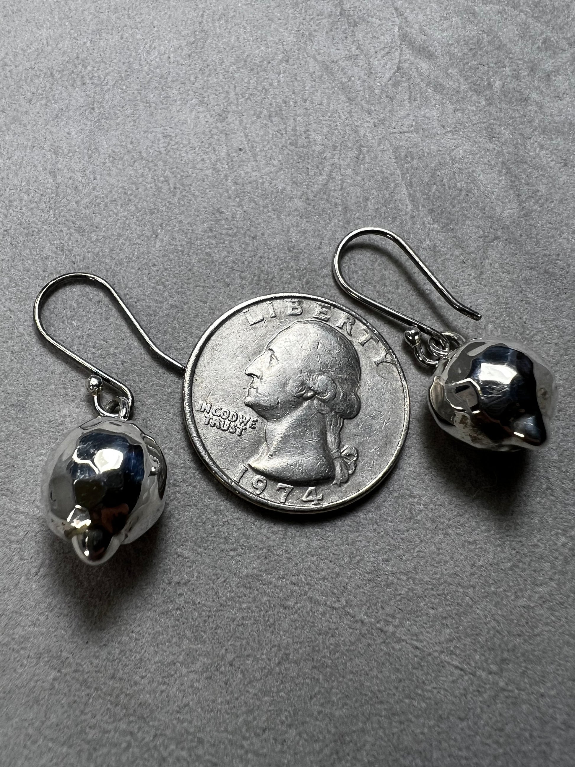 These sterling silver earrings are designed to add movement and shimmer to any outfit.