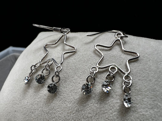 Shine like the star you are with these sterling silver earrings. They feature dangling crystals to catch the light and add extra movement to your outfit.