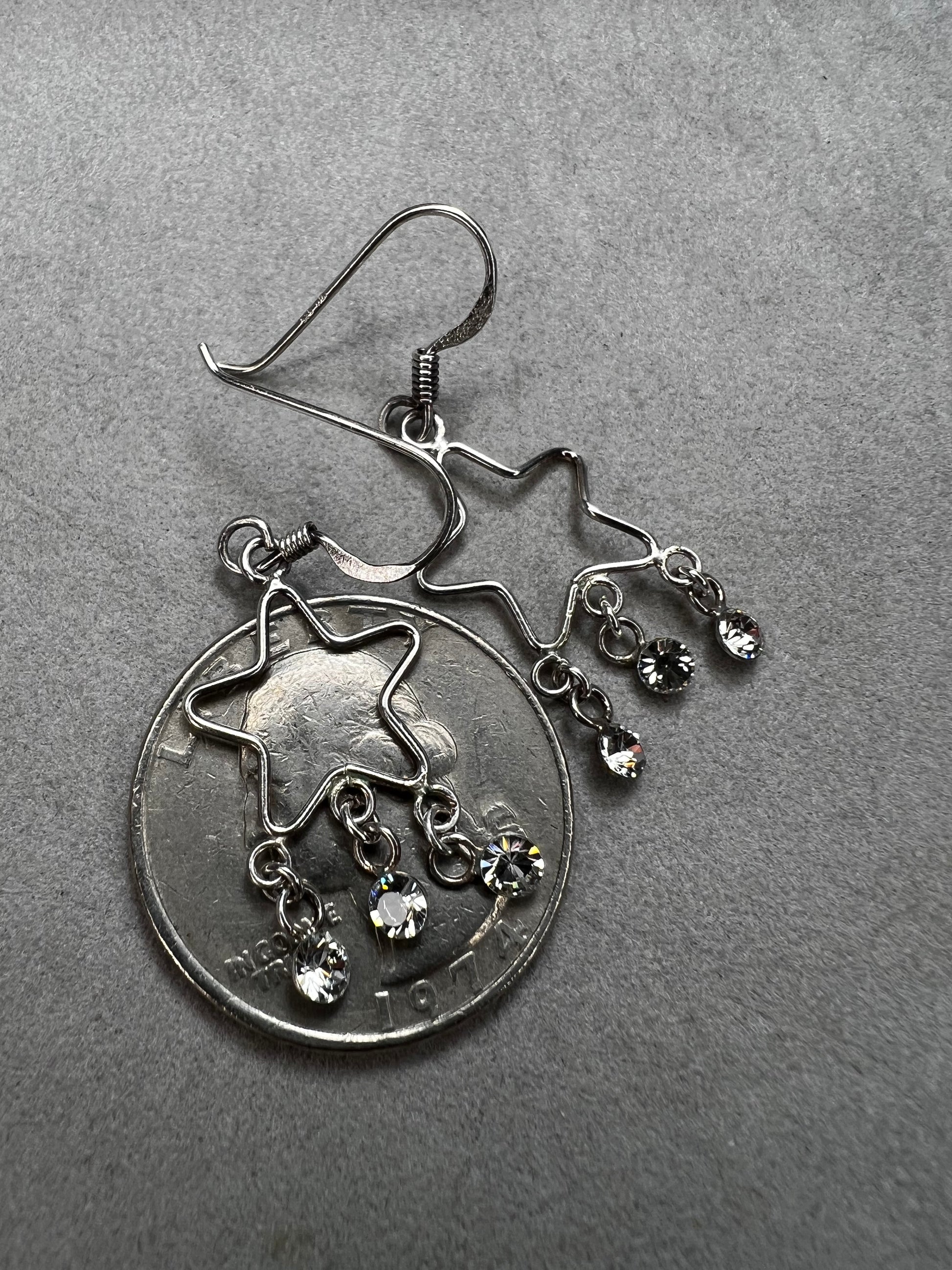 Shine like the star you are with these sterling silver earrings. They feature dangling crystals to catch the light and add extra movement to your outfit.